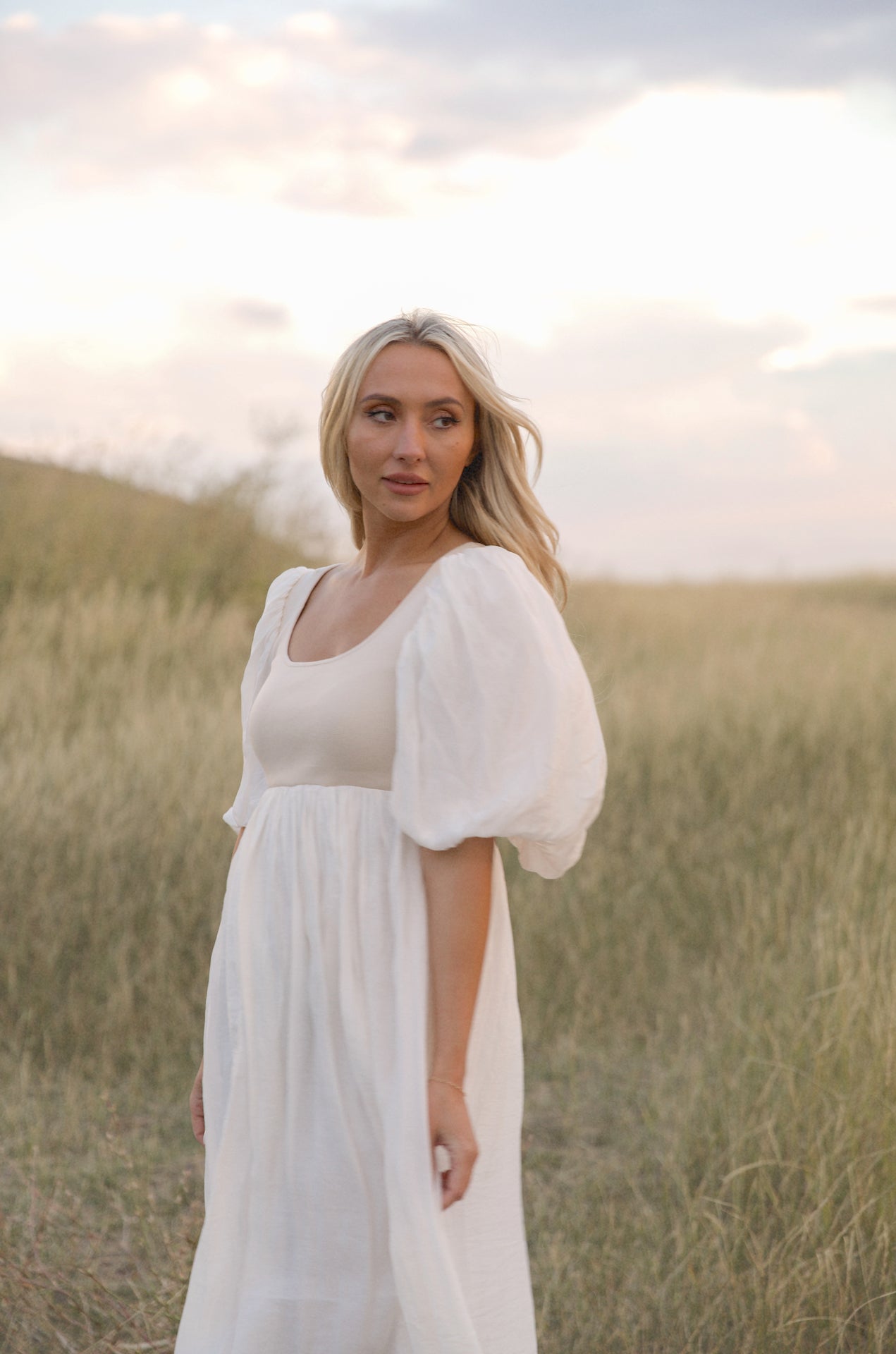 cream and white puff sleeve midi dress with a babydoll silhouette