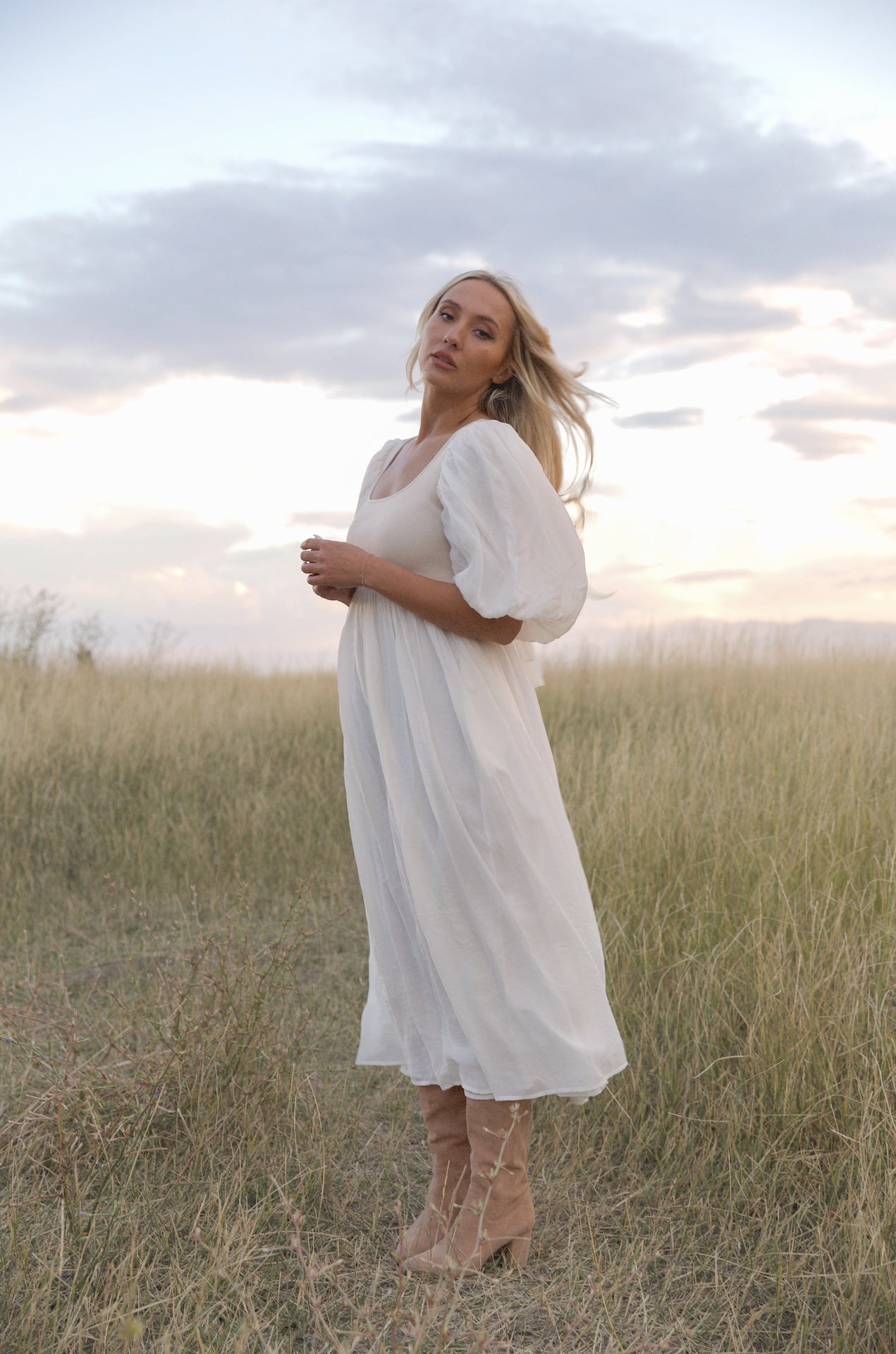 cream and white puff sleeve midi dress with a babydoll silhouette