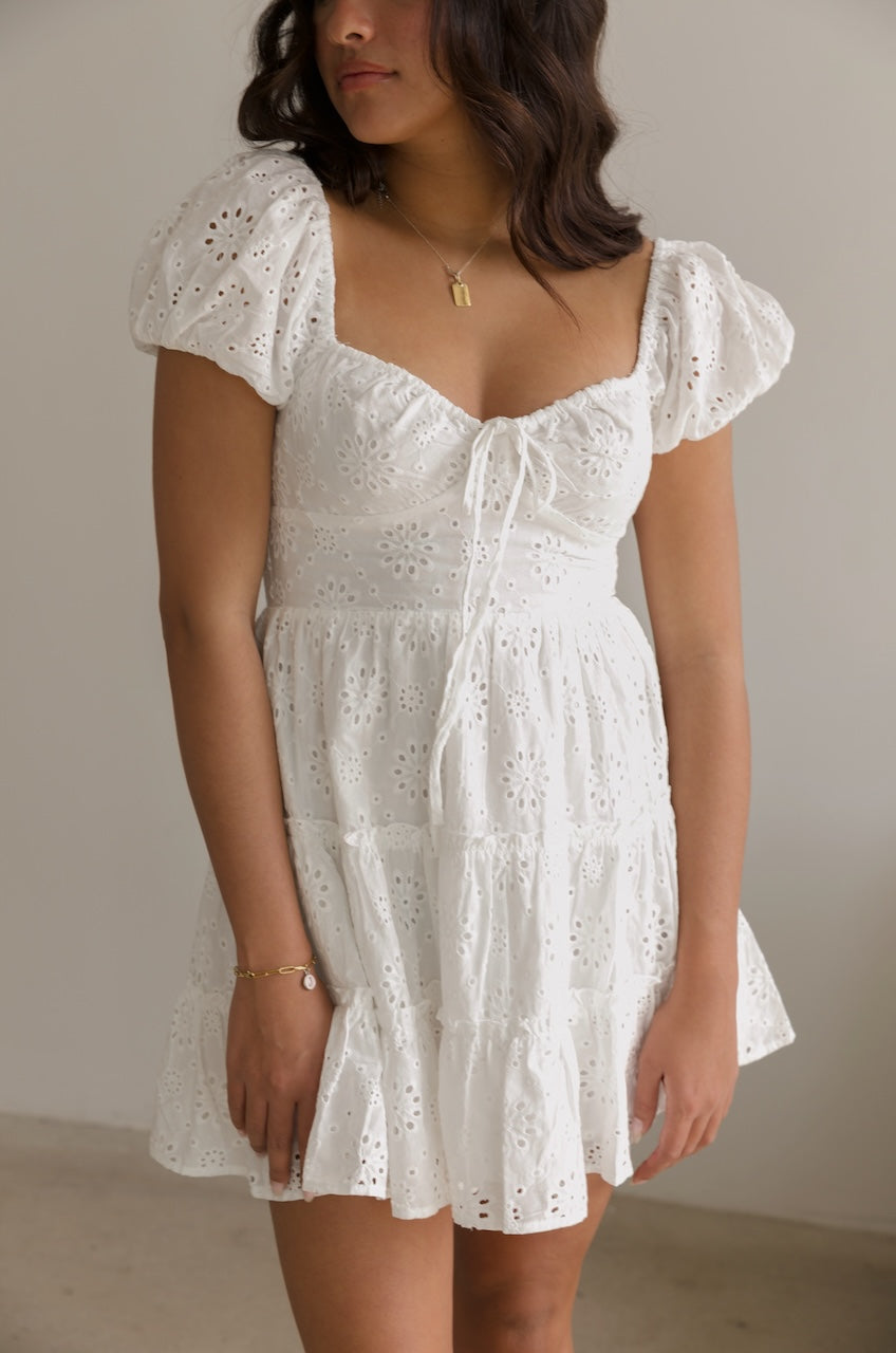 white eyelet puff sleeve tiered mini dress with a sweetheart neckline