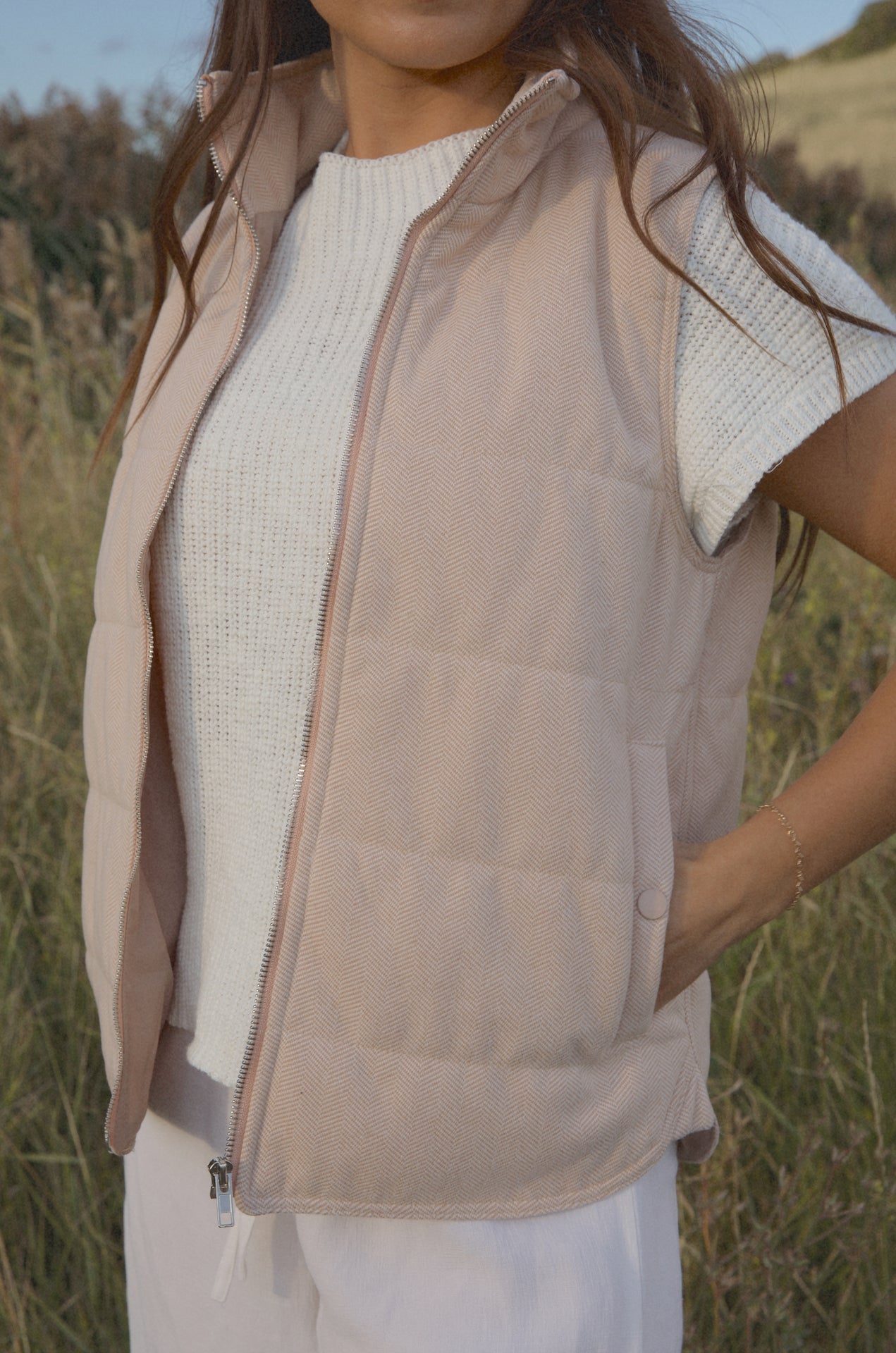 taupe padded zip up vest with a mini chevron print