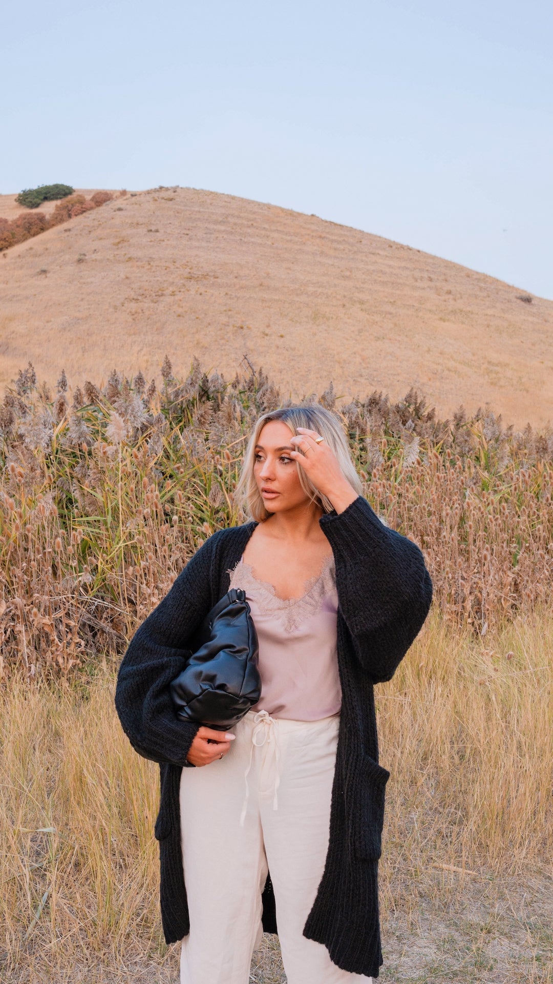 black chunky knit cardigan with pockets and balloon sleeves