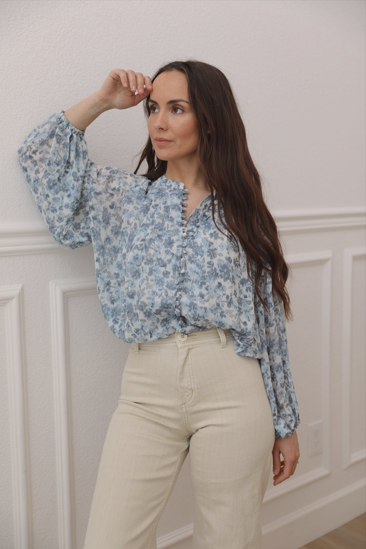 blue floral top with long sleeves and front fabric buttons