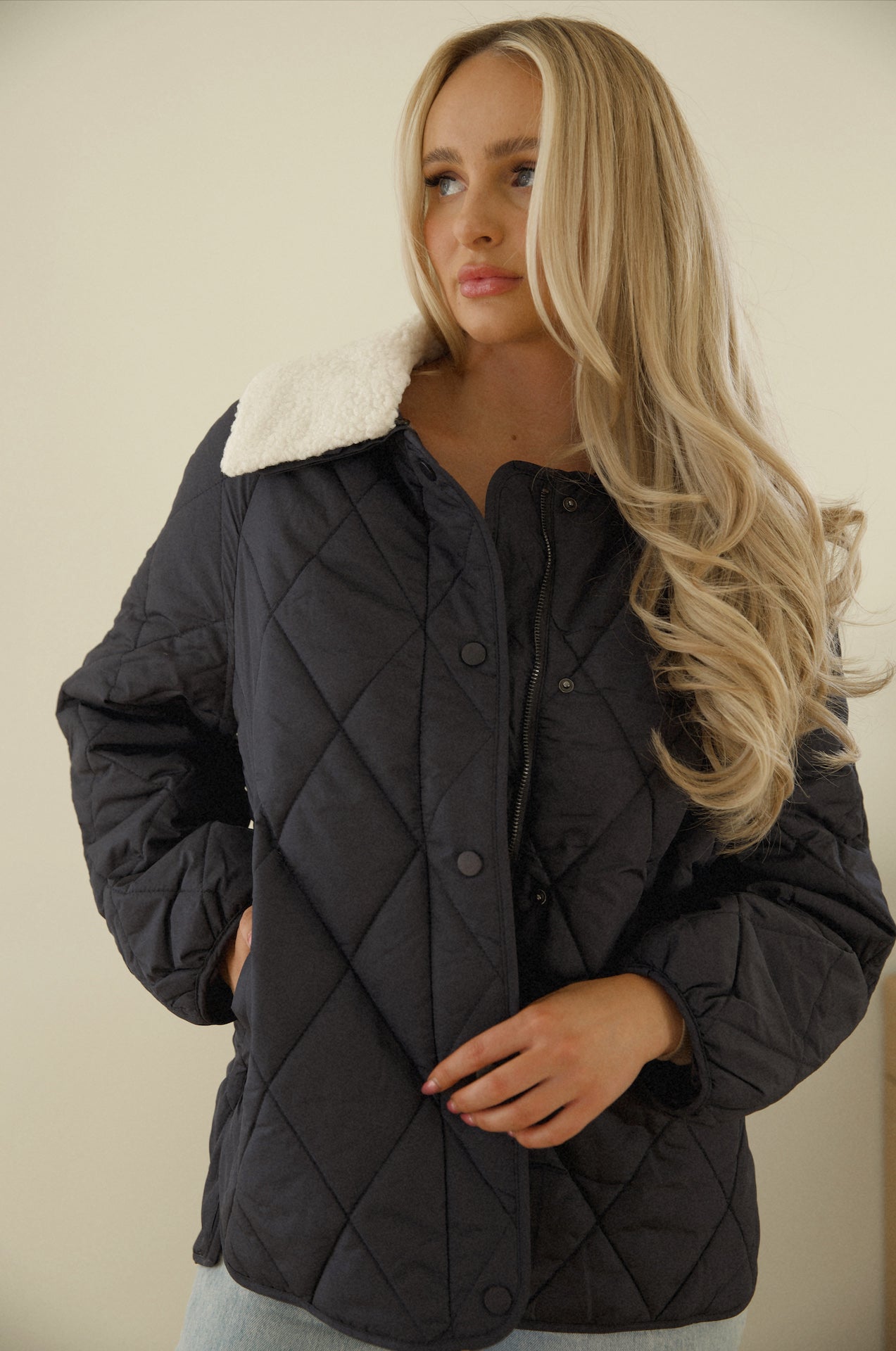 blue quilted puffer jacket with a sherpa collar