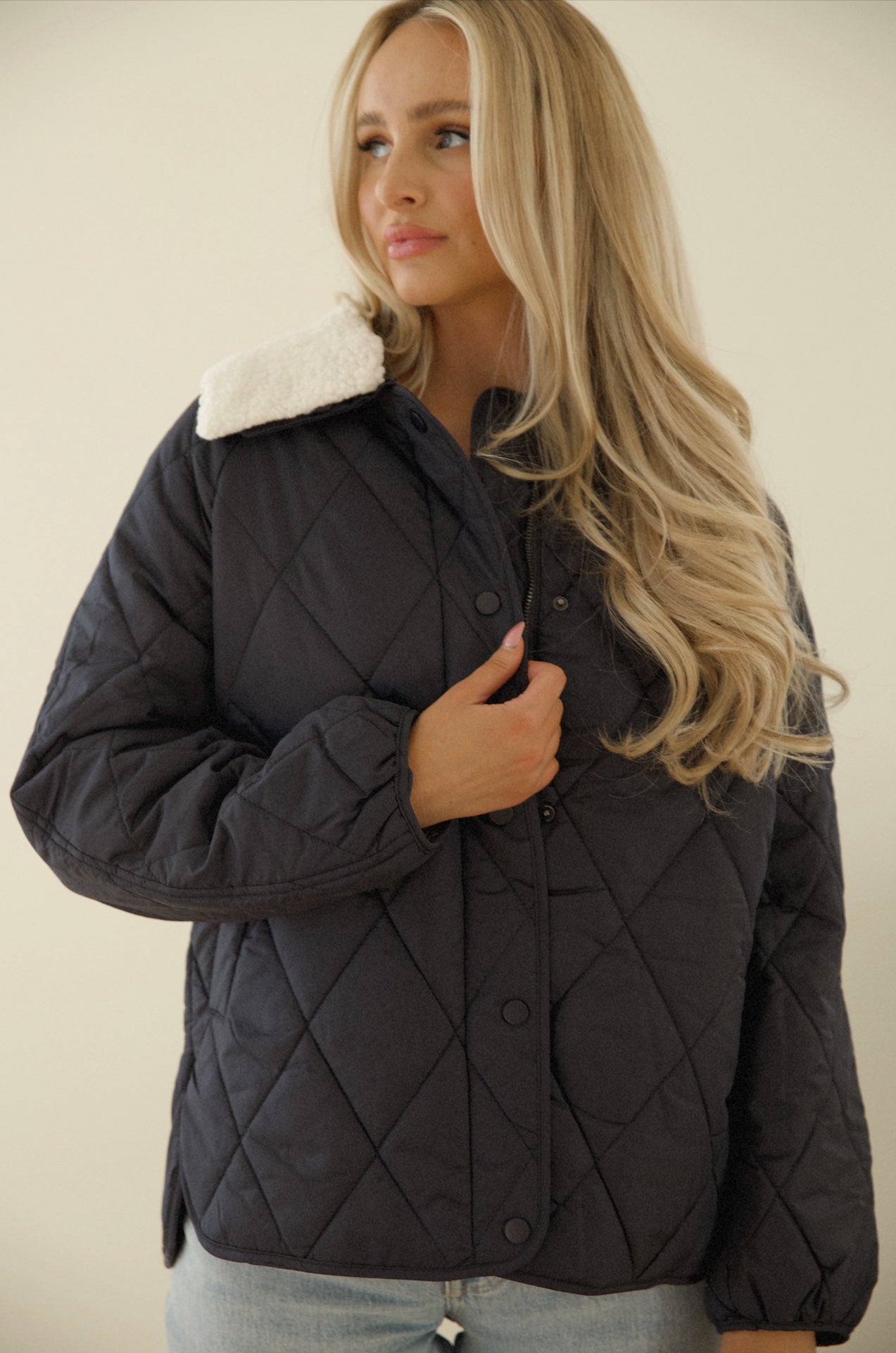 blue quilted puffer jacket with a sherpa collar