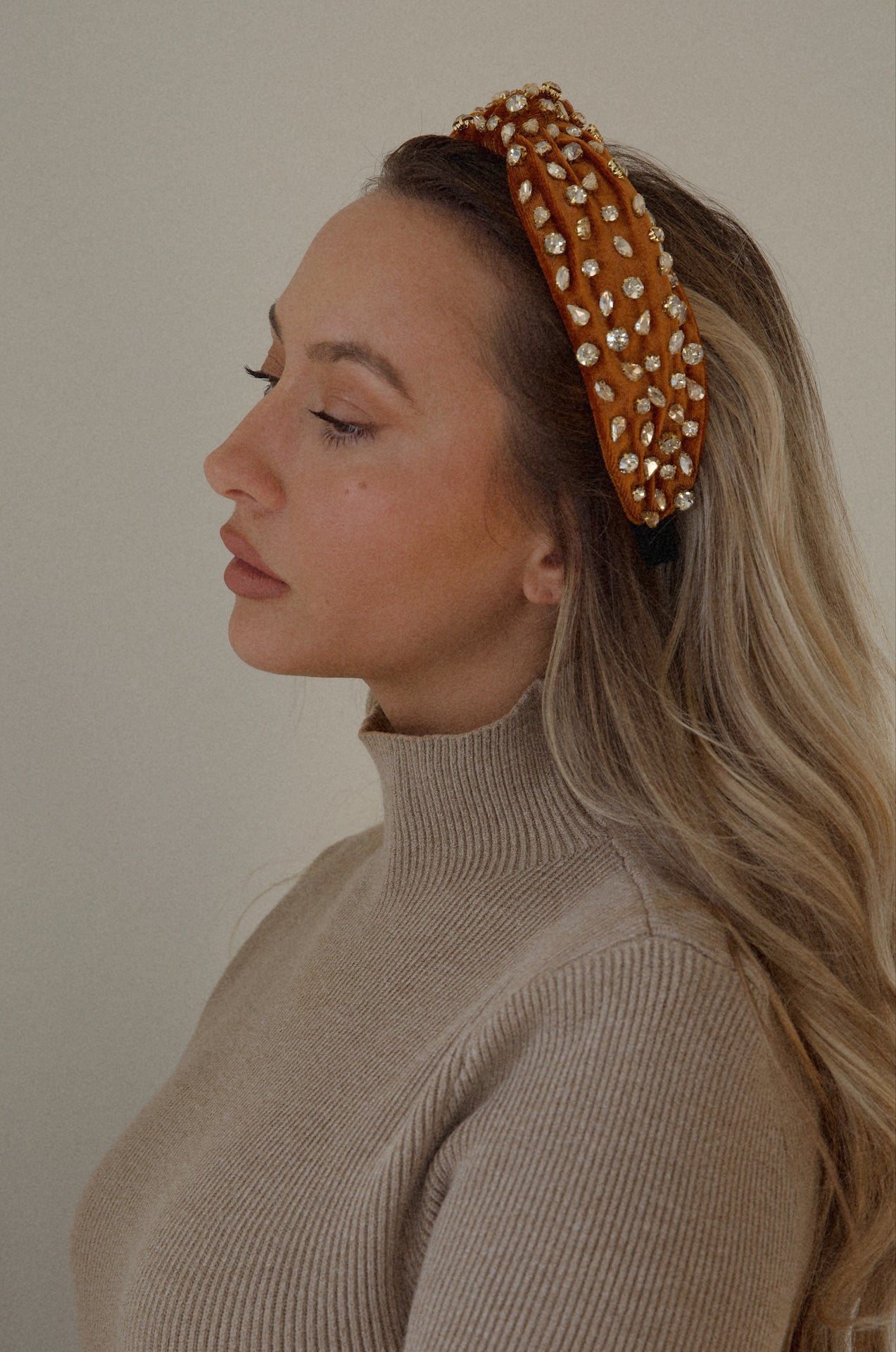 rust rhinestone headband with a top knot design