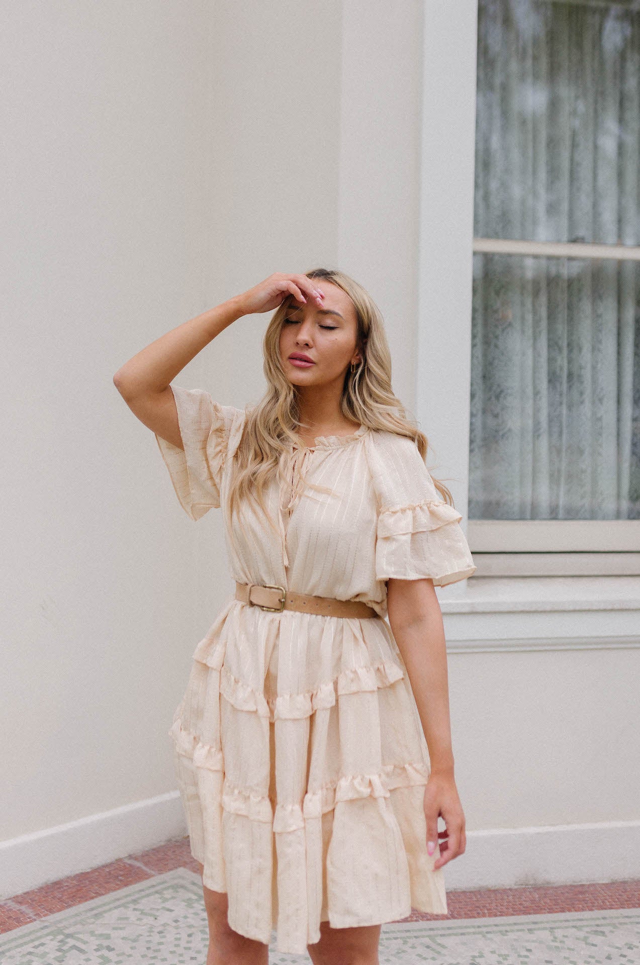 fashionable dress in cream with striped detail and ruffle