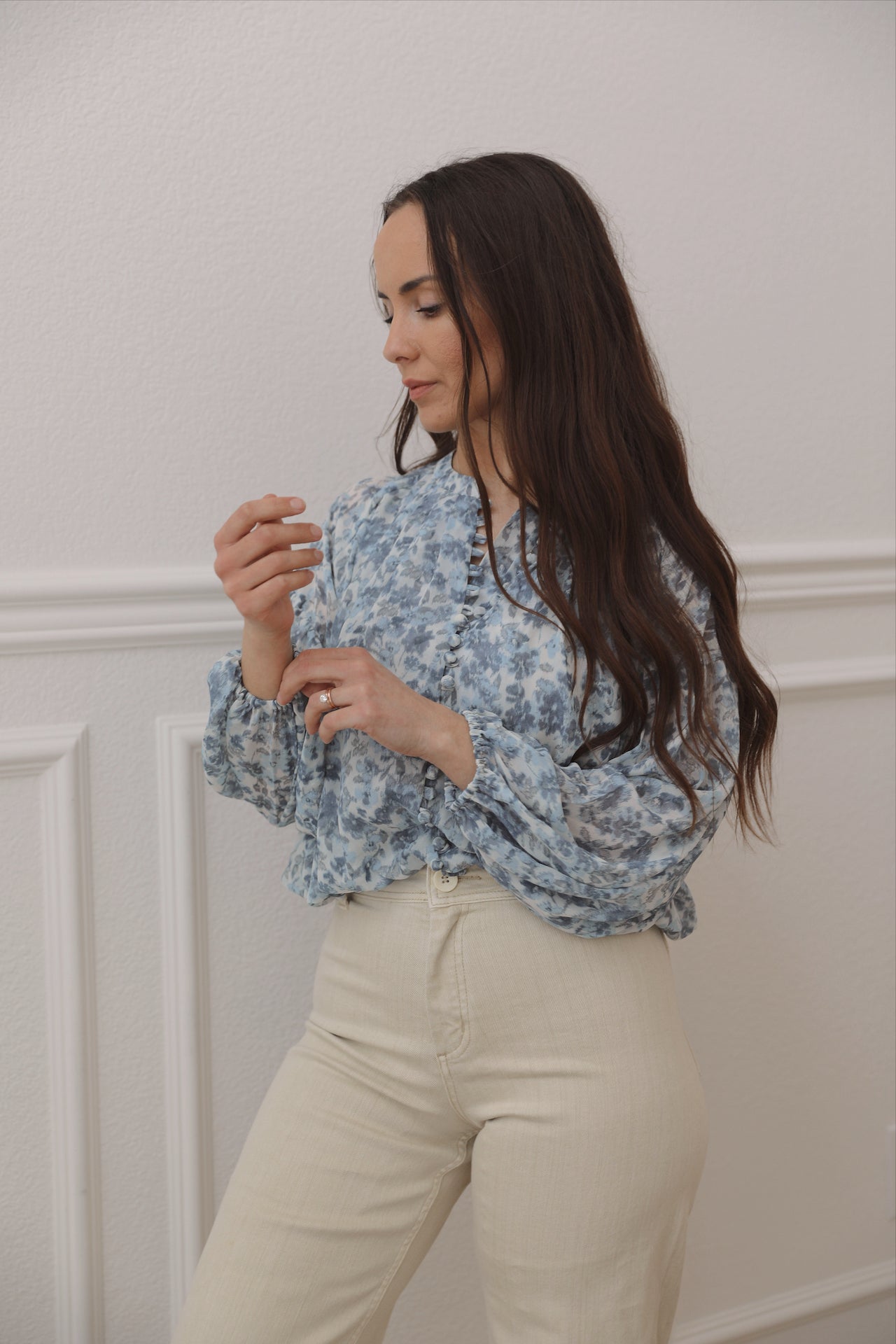blue floral top with long sleeves and an elastic waist line