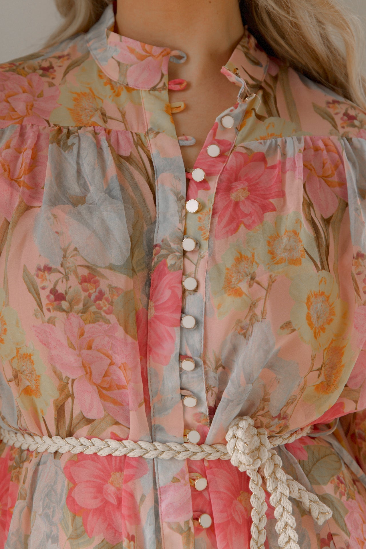 pink and blue floral sheer mini dress with long sleeves and a braided waist tie