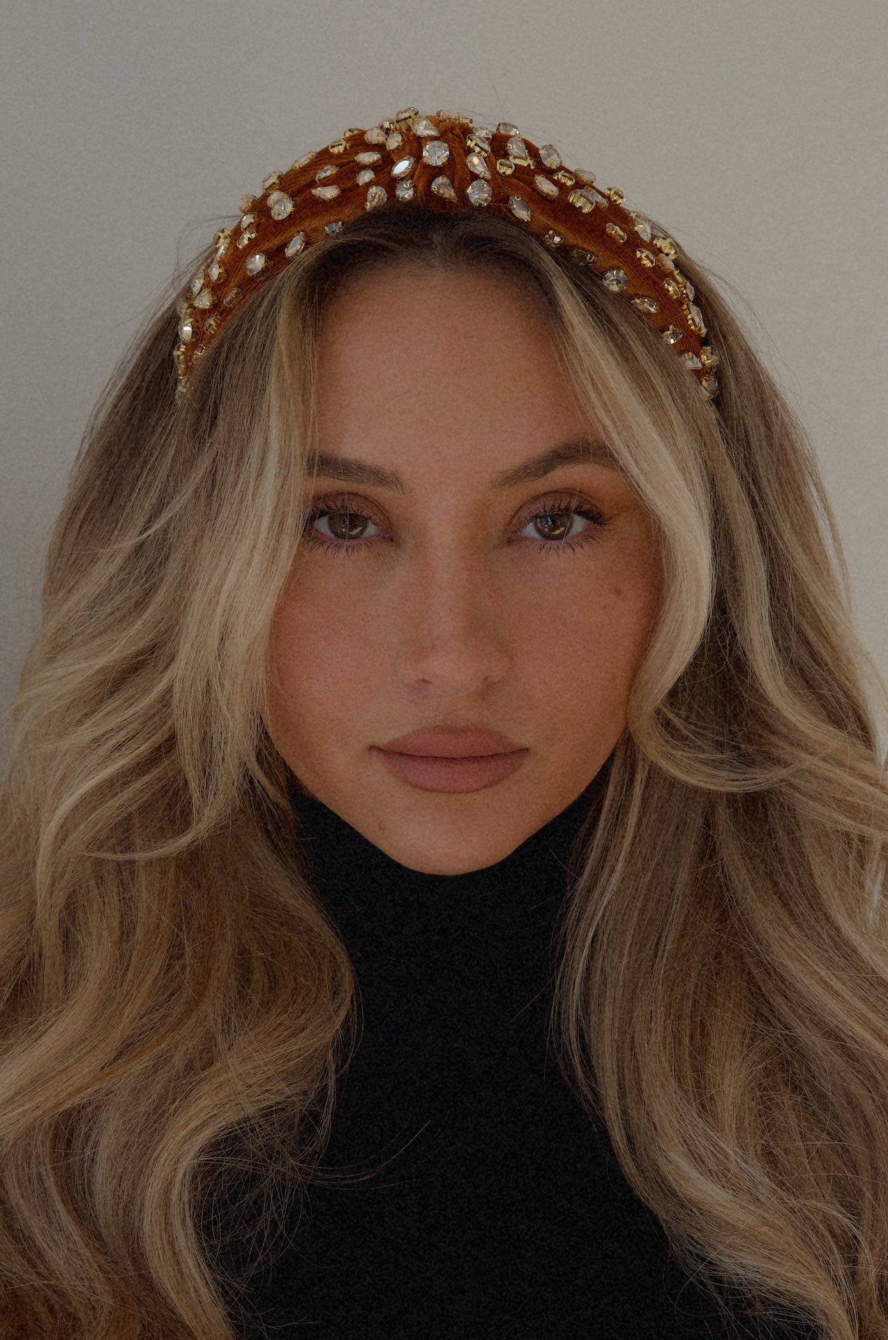 rust rhinestone headband with a top knot design