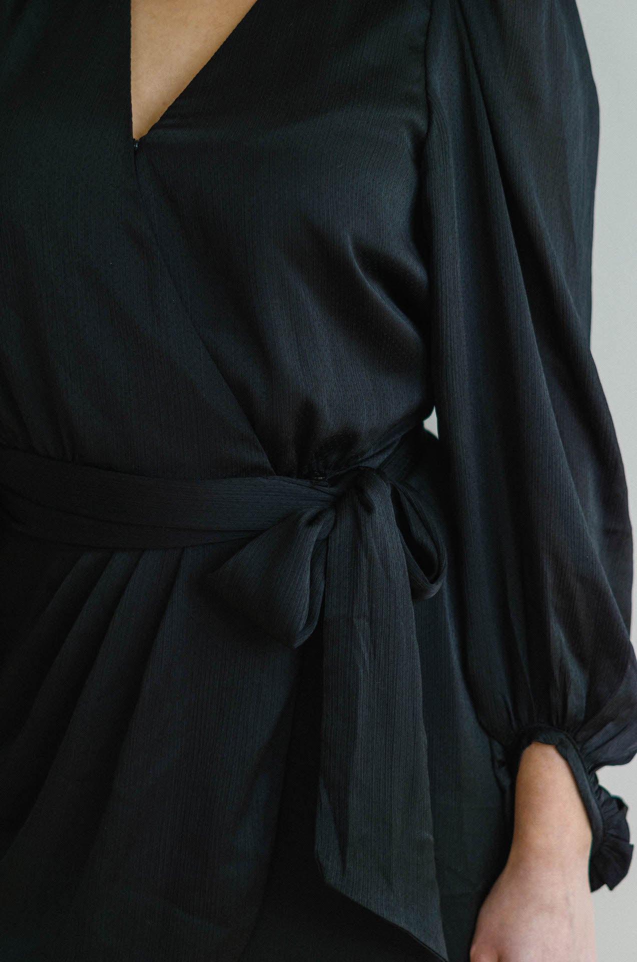 black wrap mini dress with long sleeves