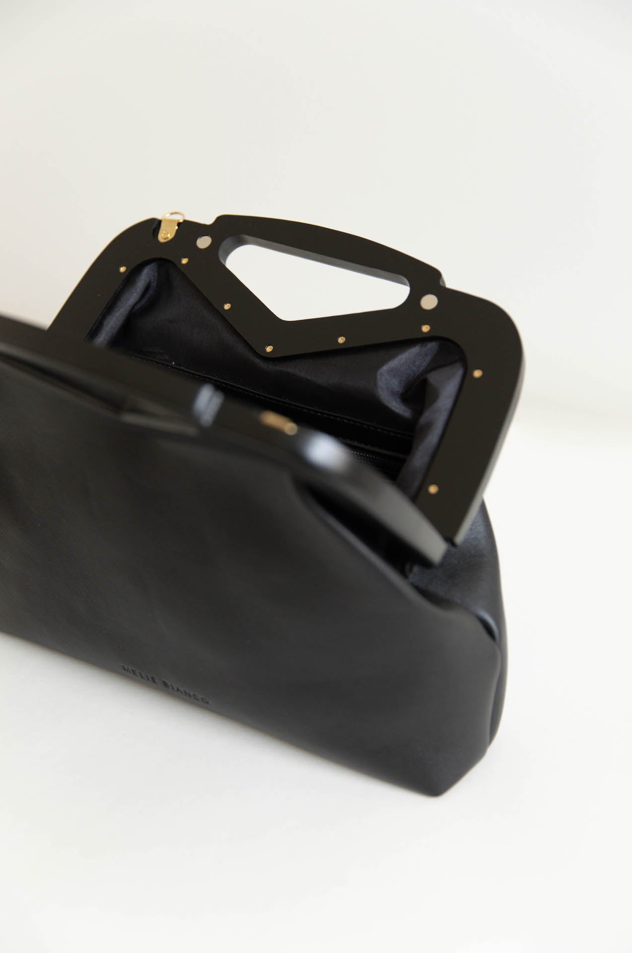 black vegan leather triangle top handle bag