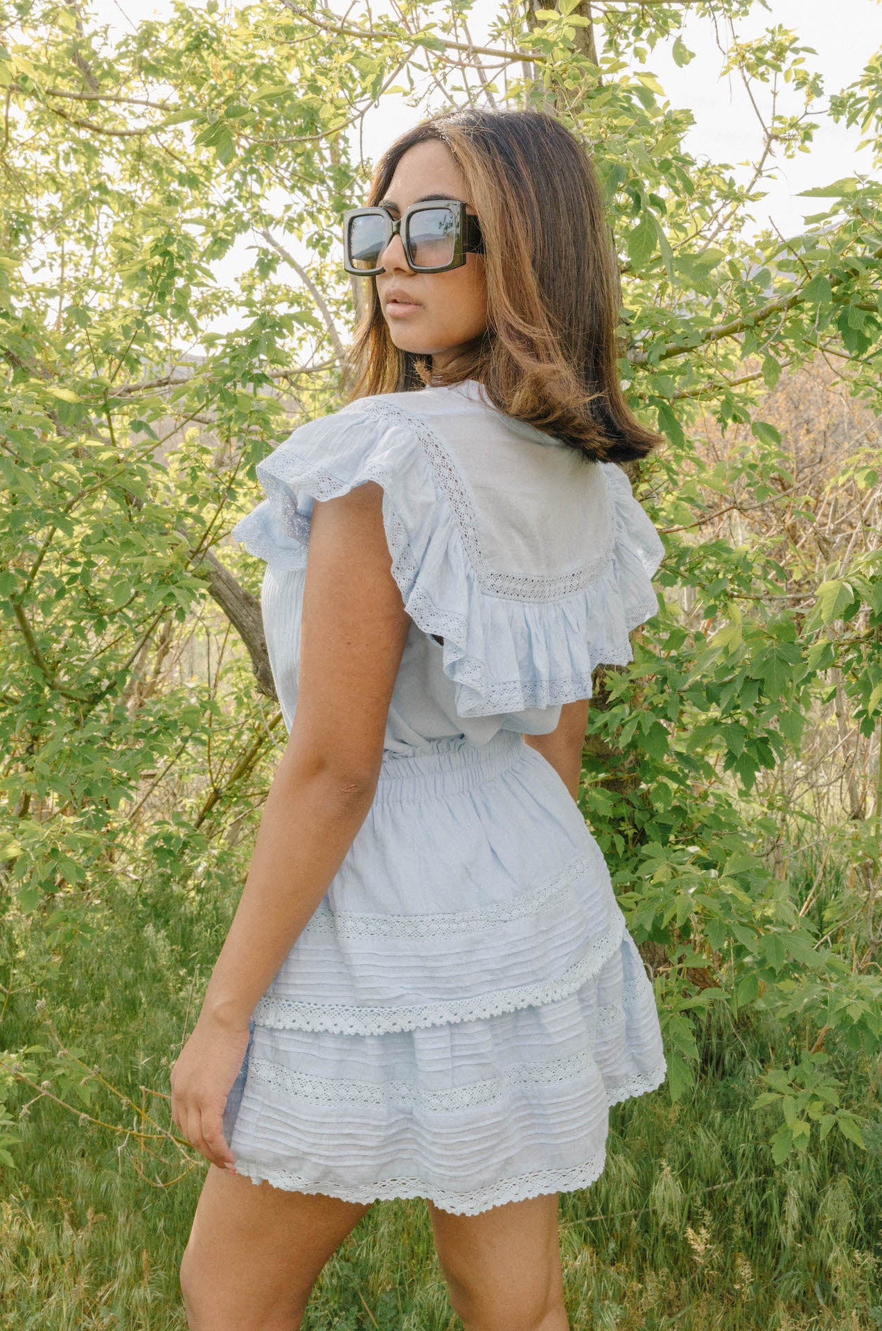 oversized black square sunglasses paired with a matching skirt and top set for summer