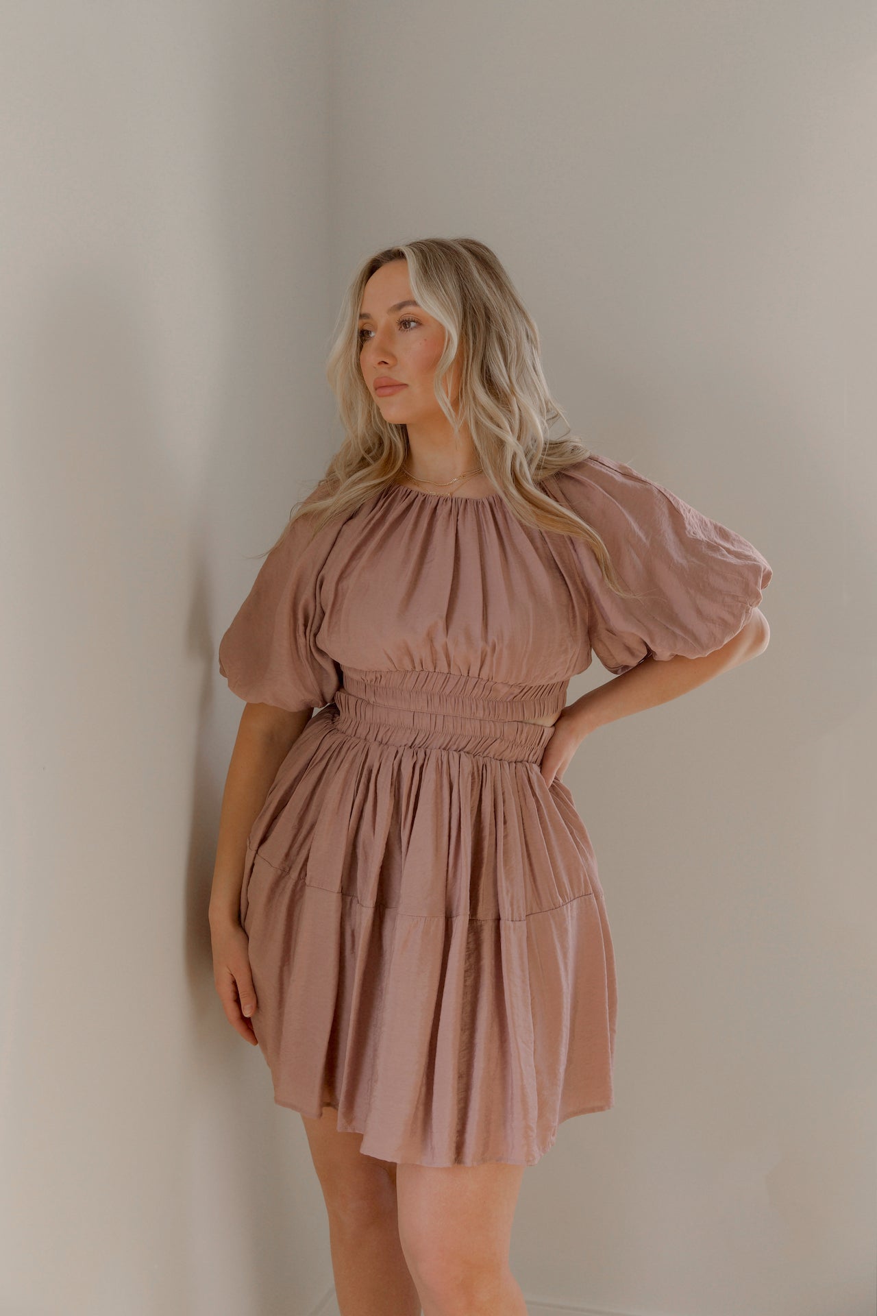 dusty mauve cut out mini dress with puff sleeves and an elastic waist