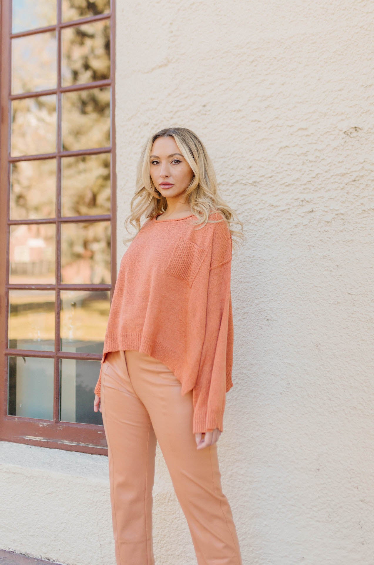 orange high waisted vegan leather pants