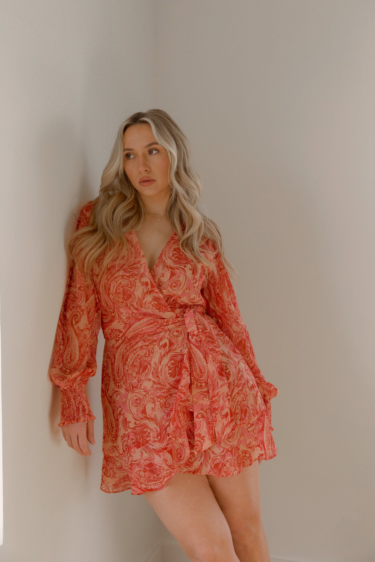 pink and orange paisley print mini wrap dress