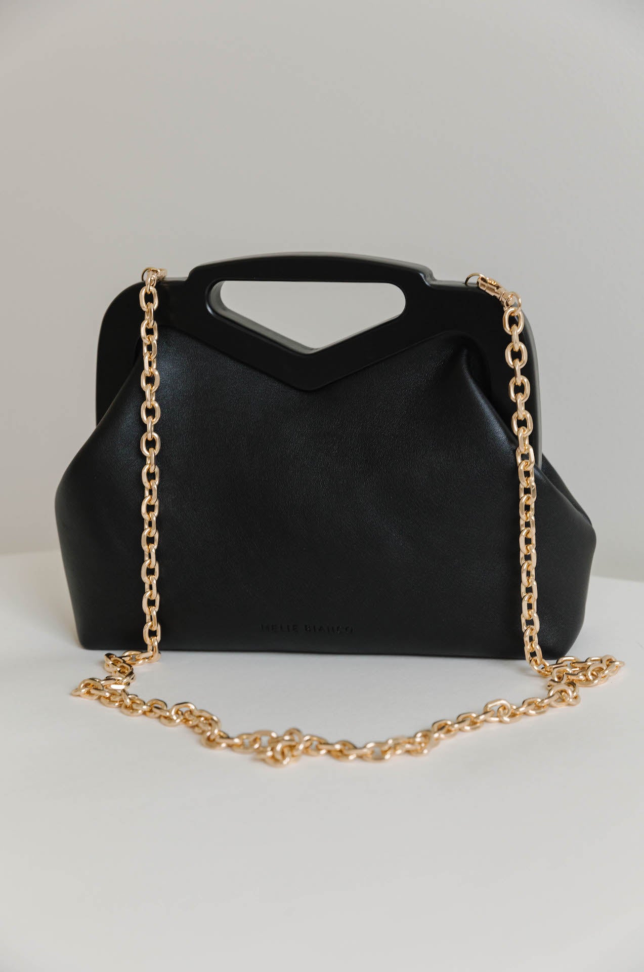 black vegan leather triangle top handle bag with gold chain