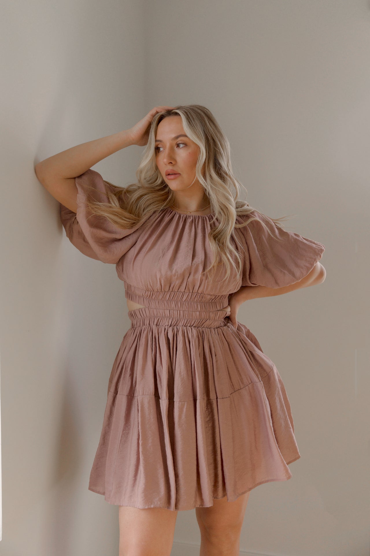 dusty mauve cut out mini dress with puff sleeves and an elastic waist