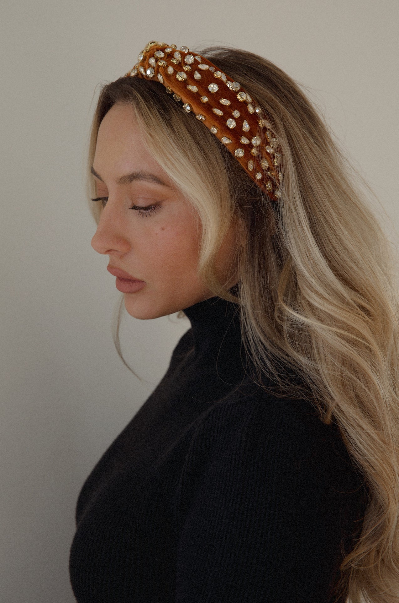 rust rhinestone headband with a top knot design