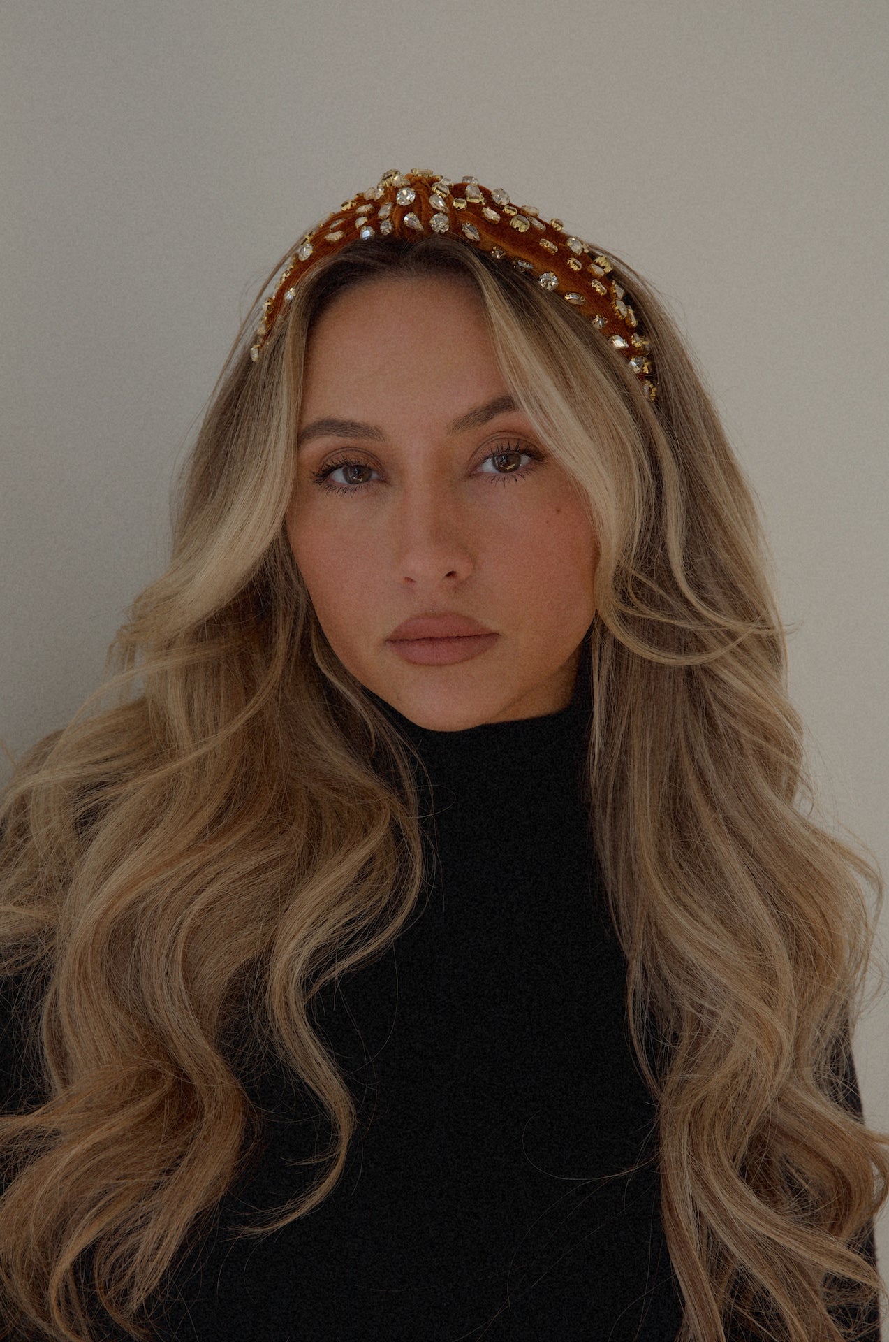 rust rhinestone headband with a top knot design