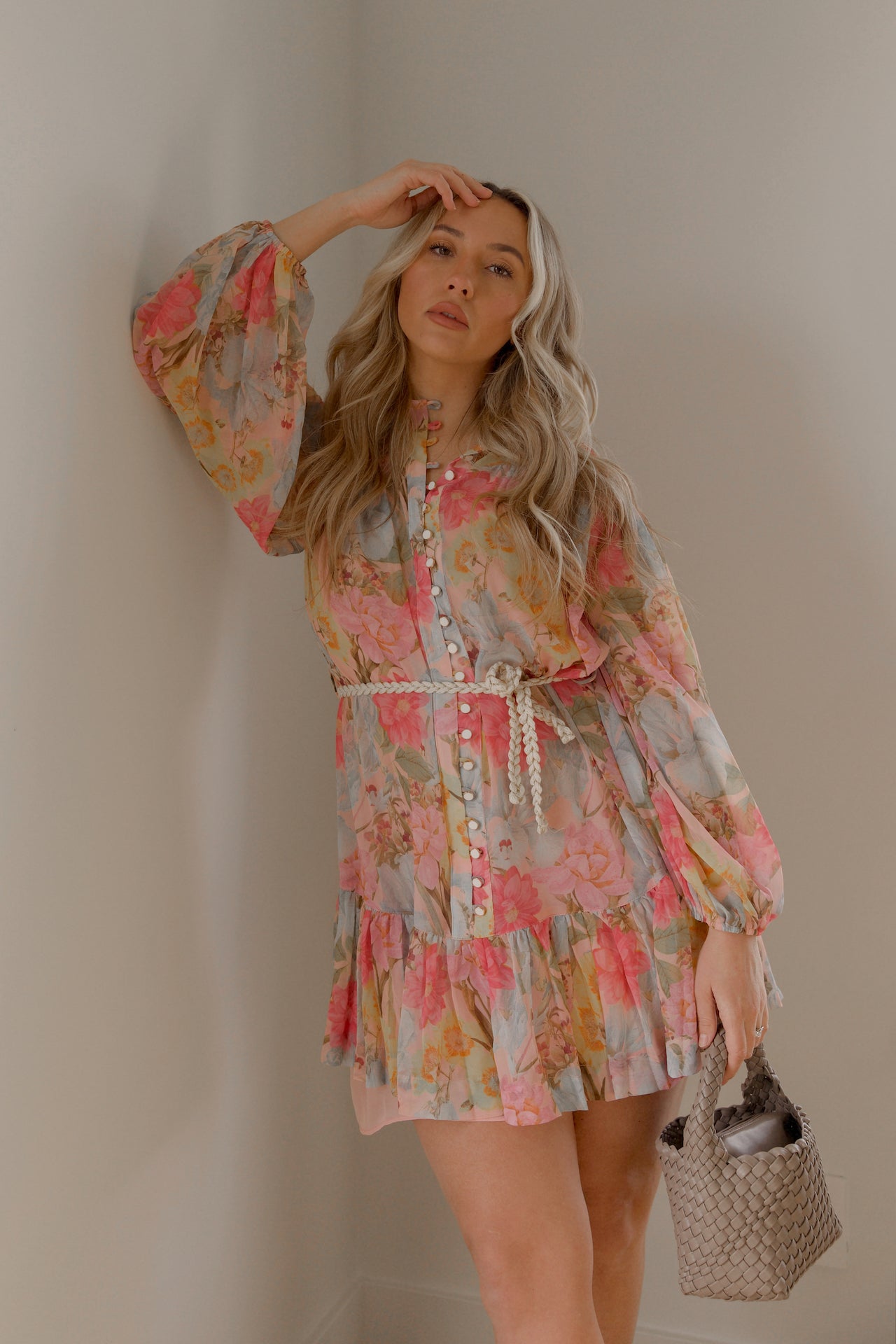 pink and blue floral sheer mini dress with long sleeves and a braided waist tie