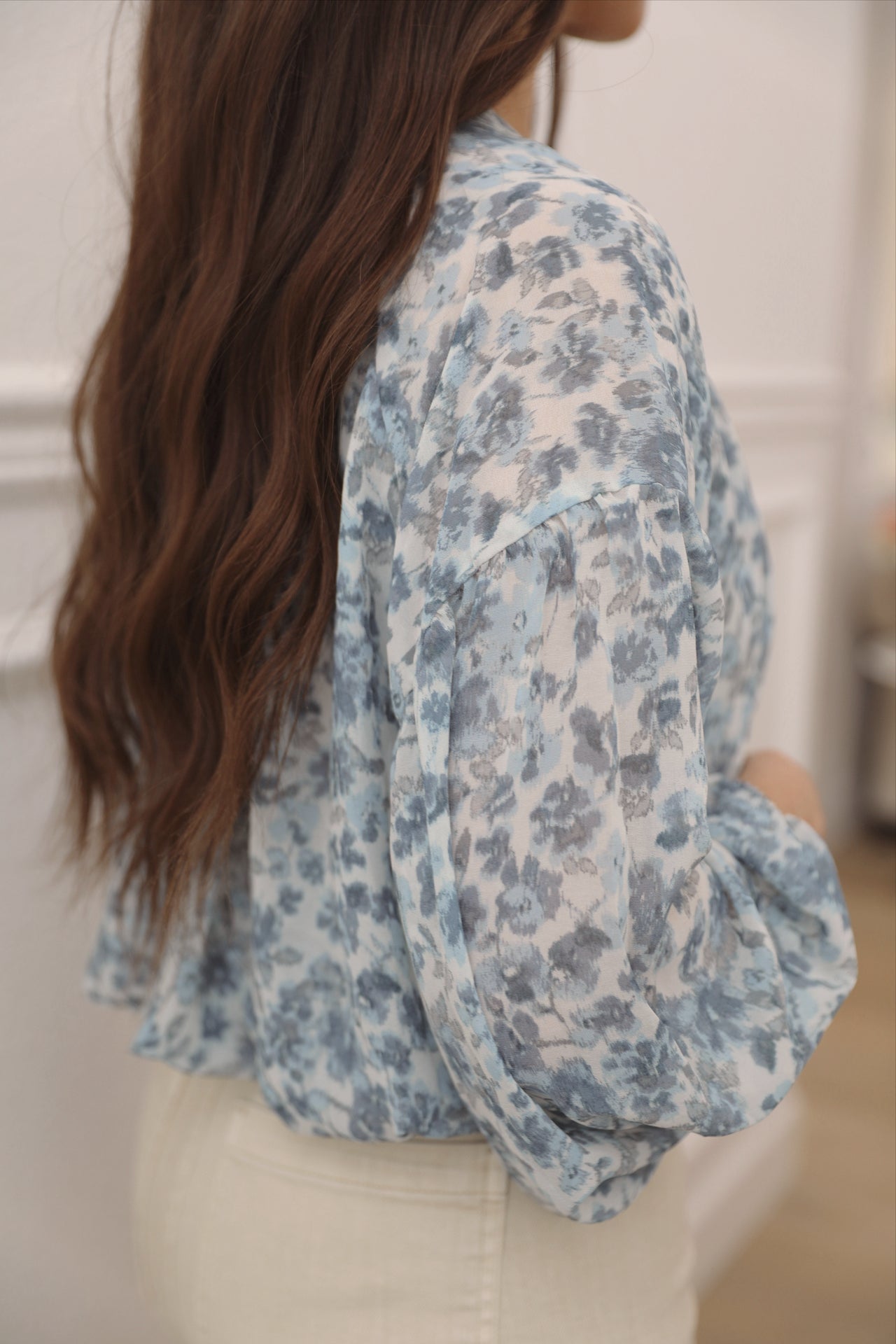 blue floral top with long sleeves and front fabric buttons