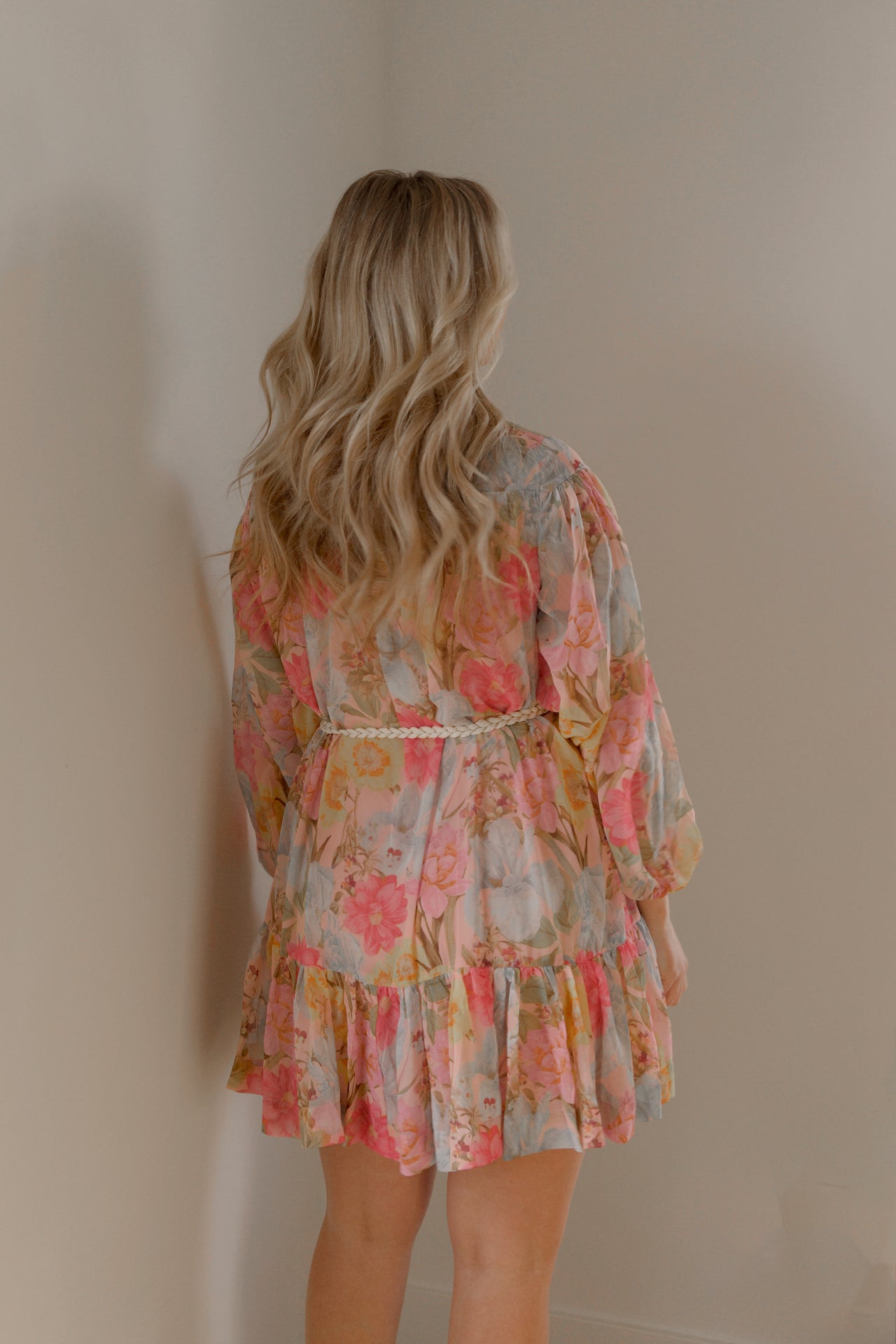 pink and blue floral sheer mini dress with long sleeves and a braided waist tie