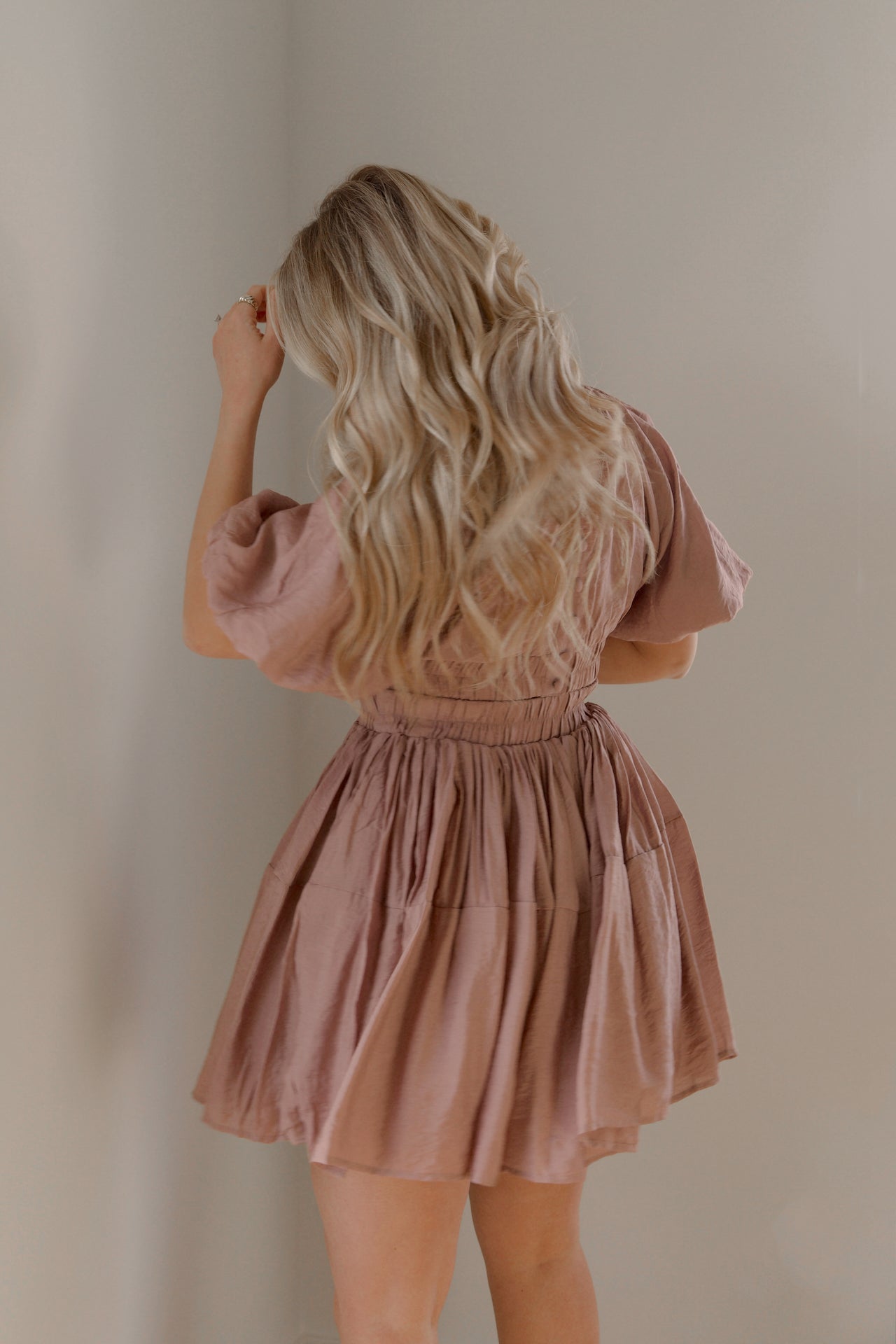 dusty mauve cut out mini dress with puff sleeves and an elastic waist