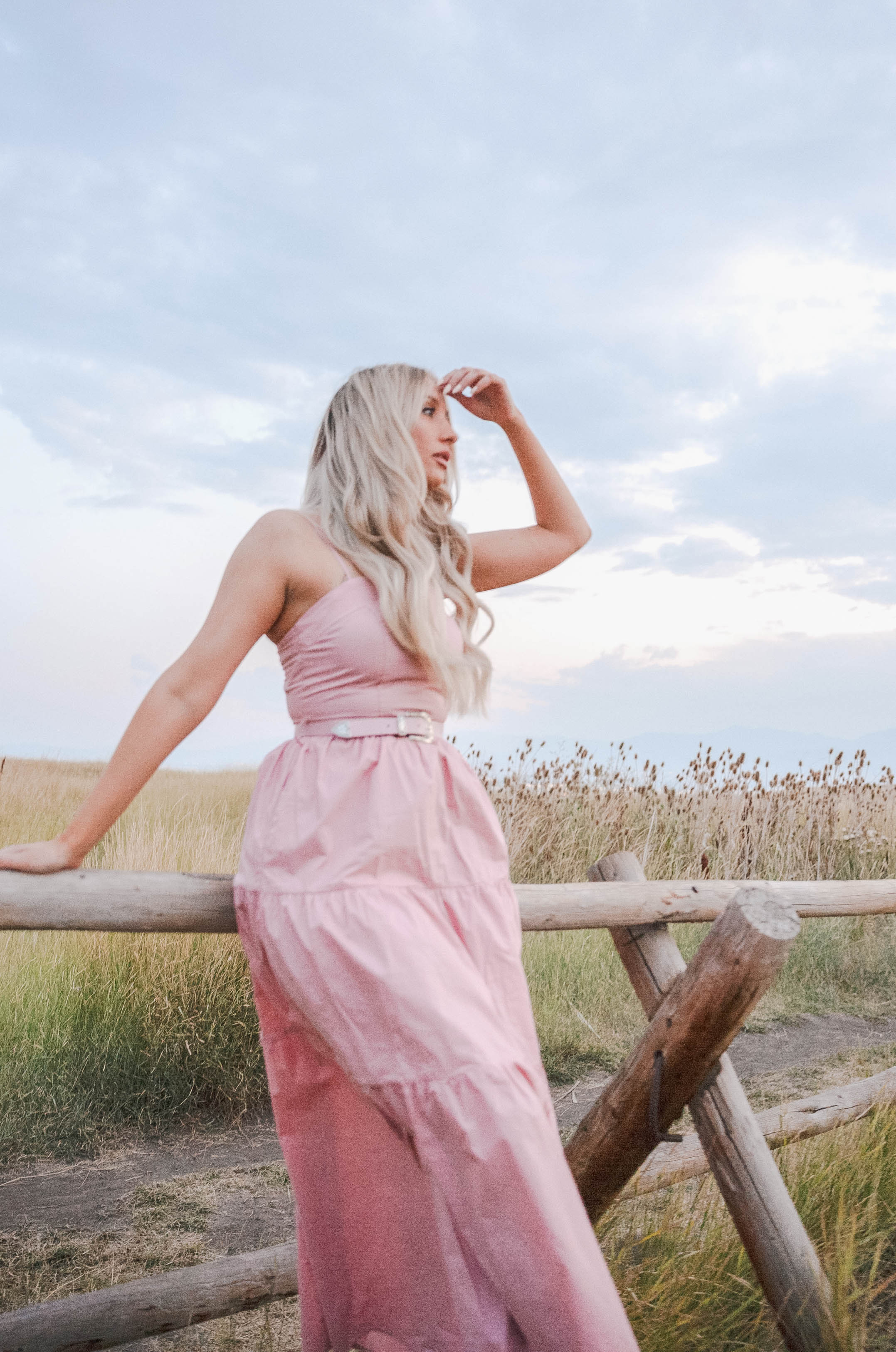 blush pink maxi dress with a belt and tired detail