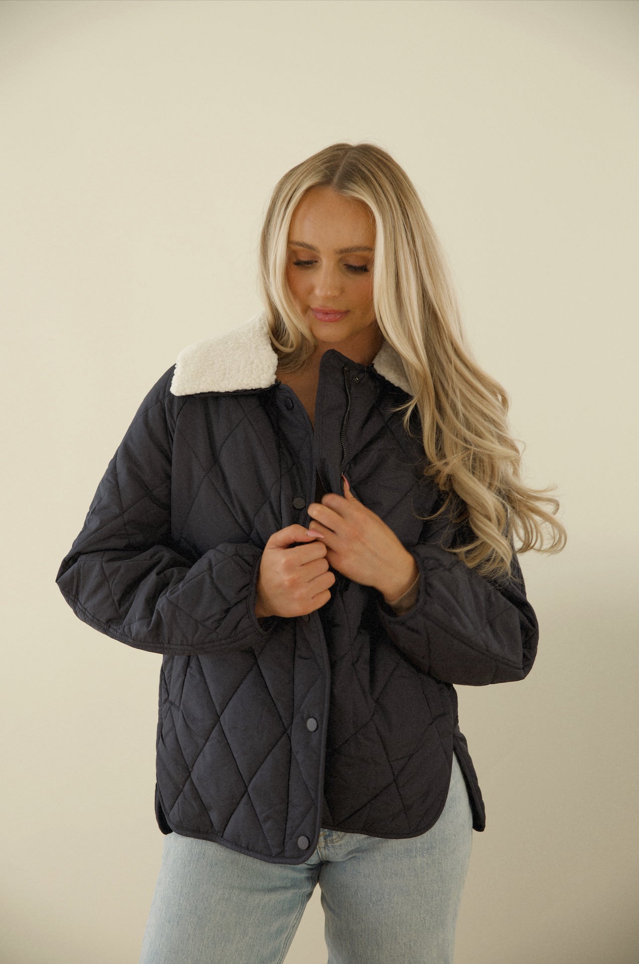 blue quilted puffer jacket with a sherpa collar