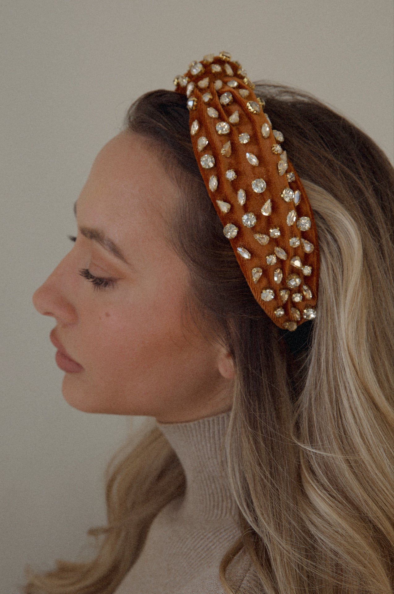 rust rhinestone headband with a top knot design