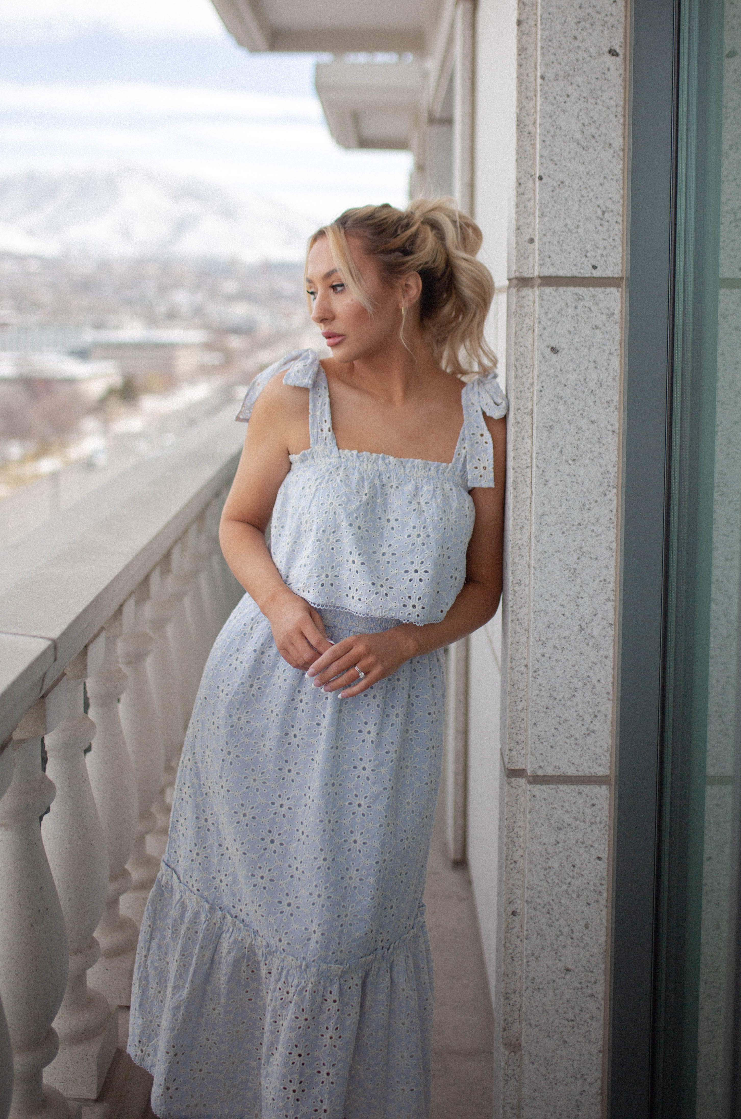 blue eyelet summer midi dress with ruffle detailing and tied shoulder straps