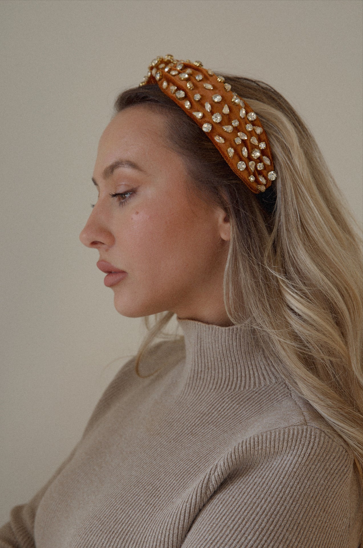rust rhinestone headband with a top knot design