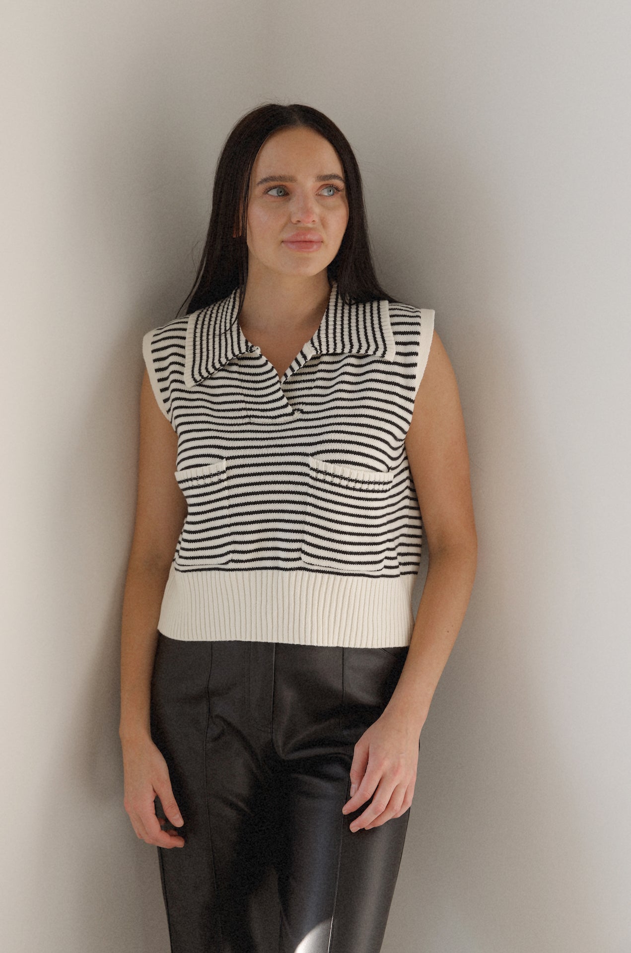 black and white striped sweater vest that is collared with pockets