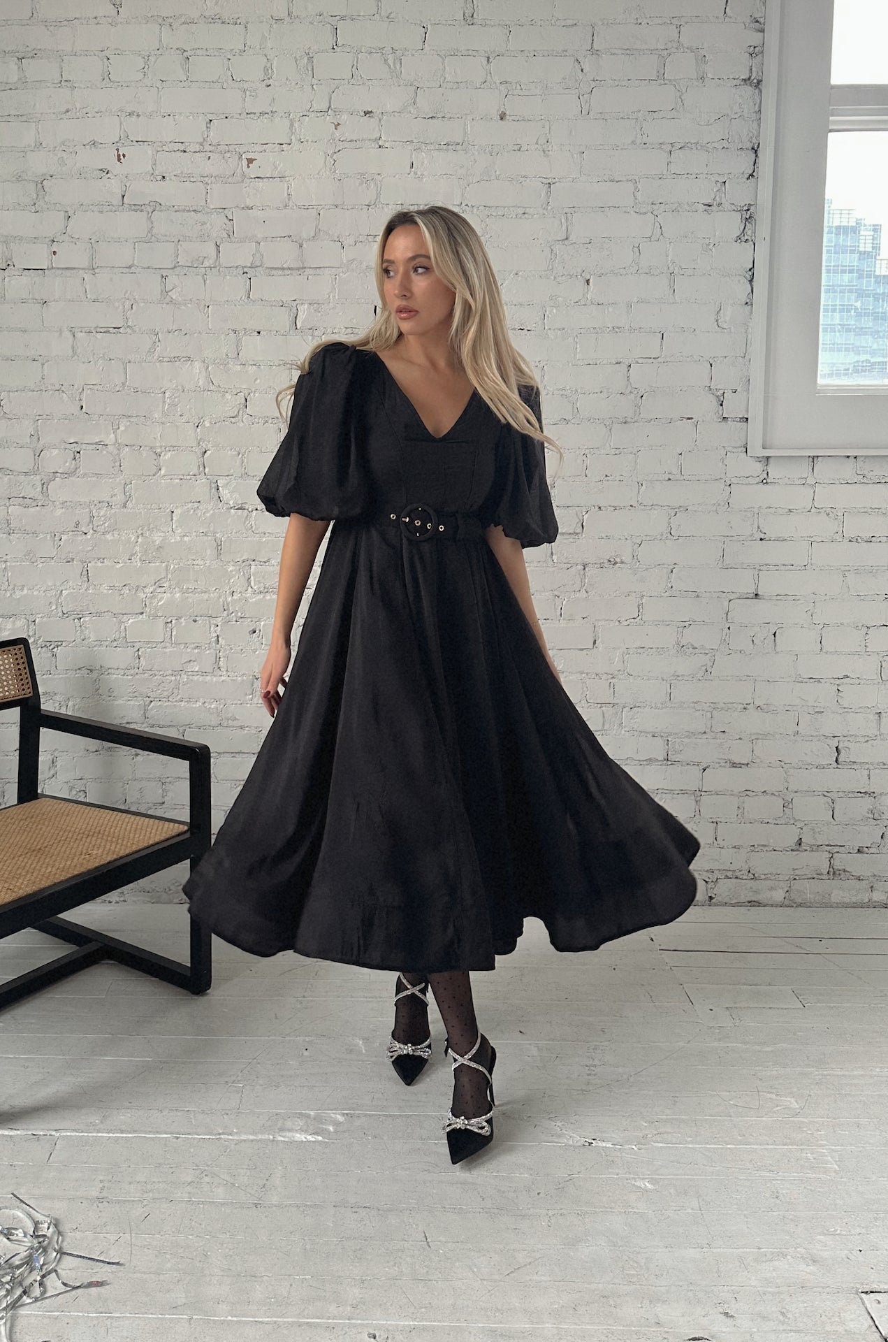 black puff sleeve midi dress with a belt and v-neckline