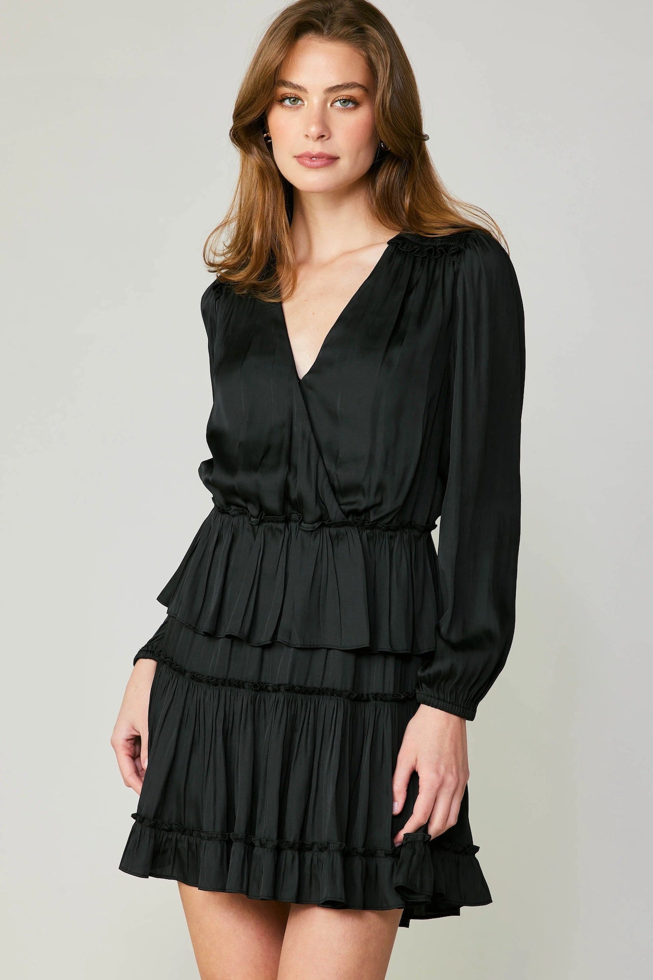 black tiered mini dress with long sleeves and pleated detail