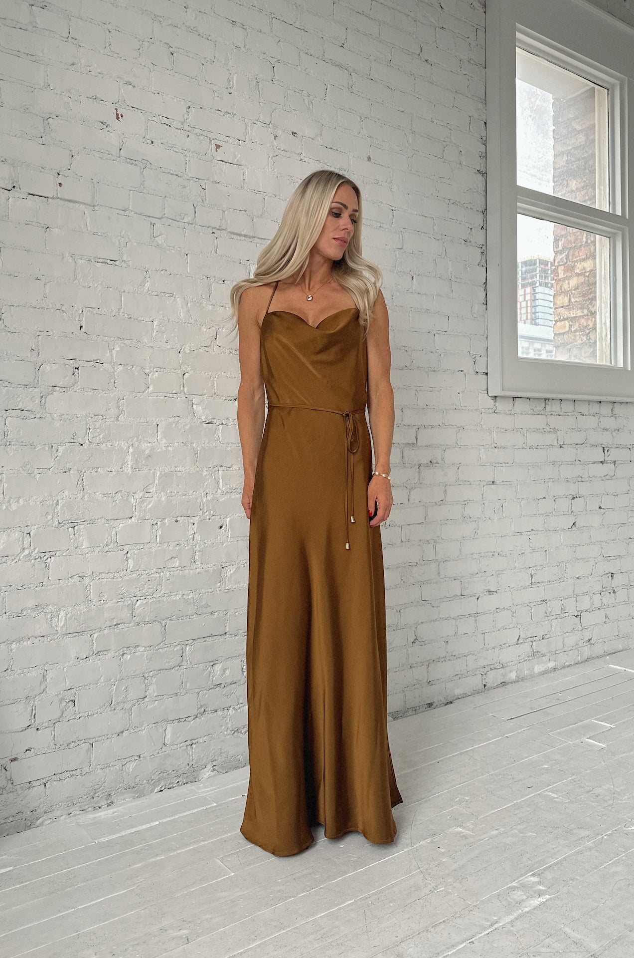 bronze brown satin maxi dress with a cowl neckline and criss cross back