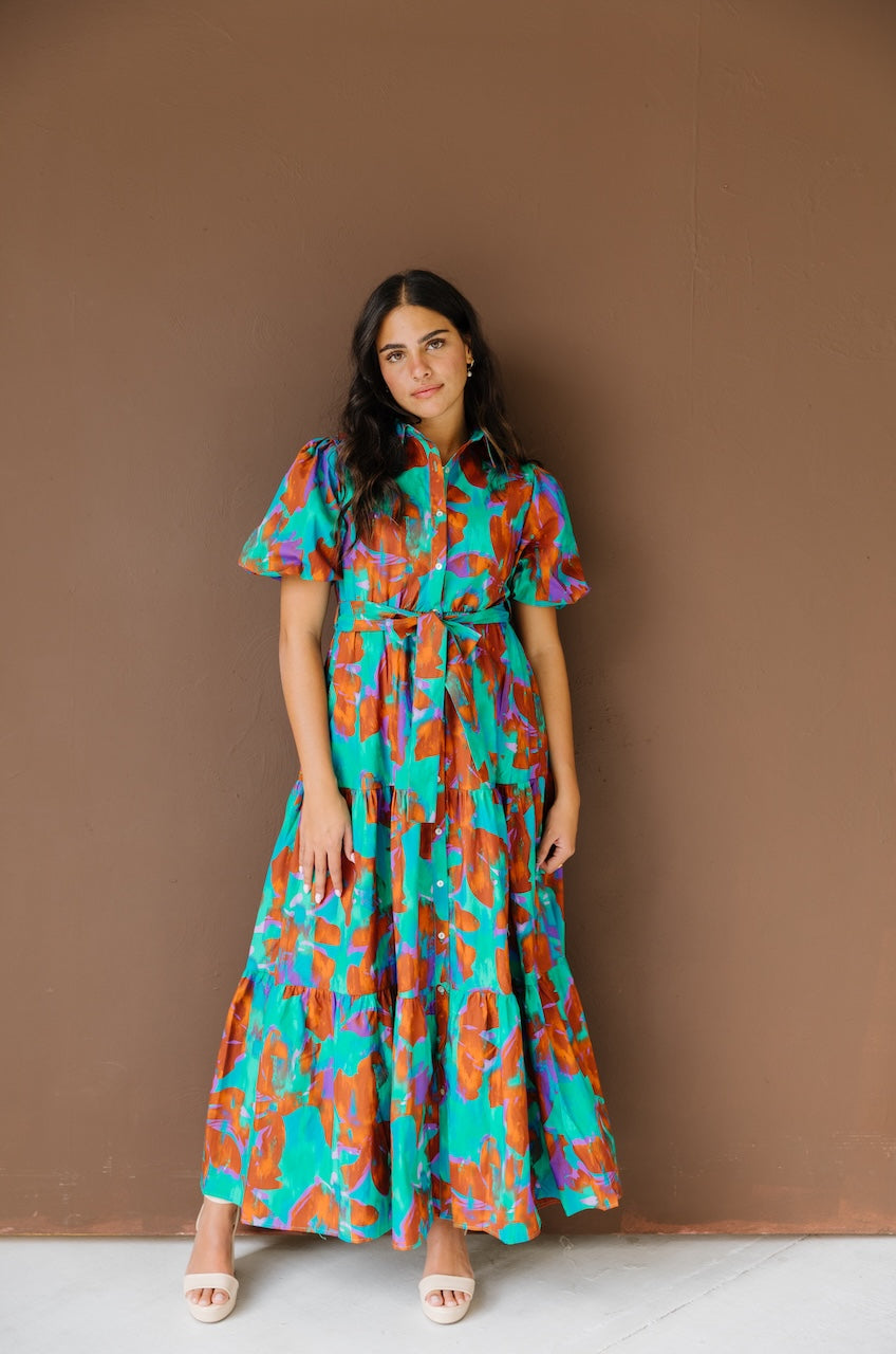 Green and brown puff sleeve button down cotton shirt dress with maxi length, waist tie and side pockets.
