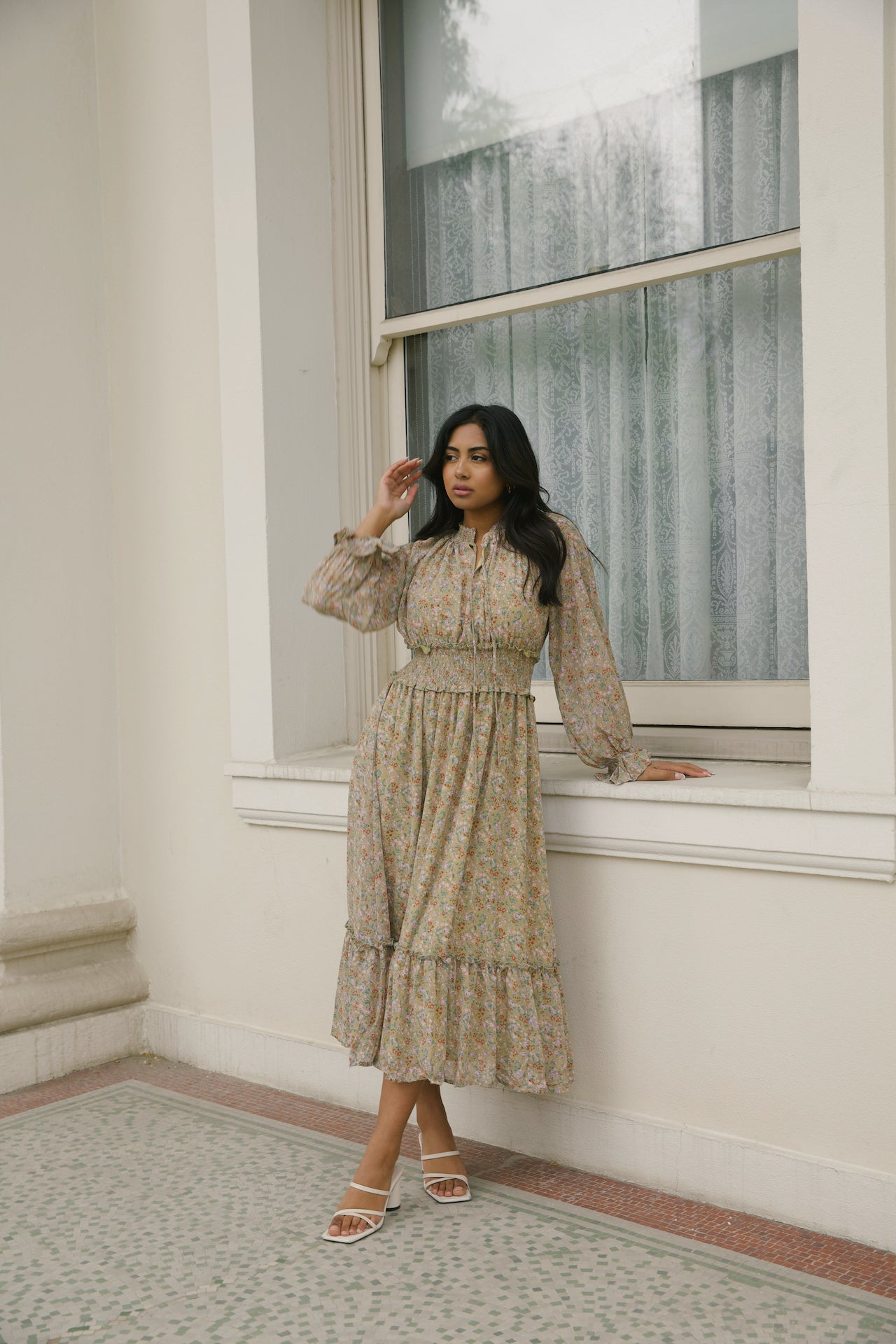 green floral midi dress with long sleeves and a smocked waistline