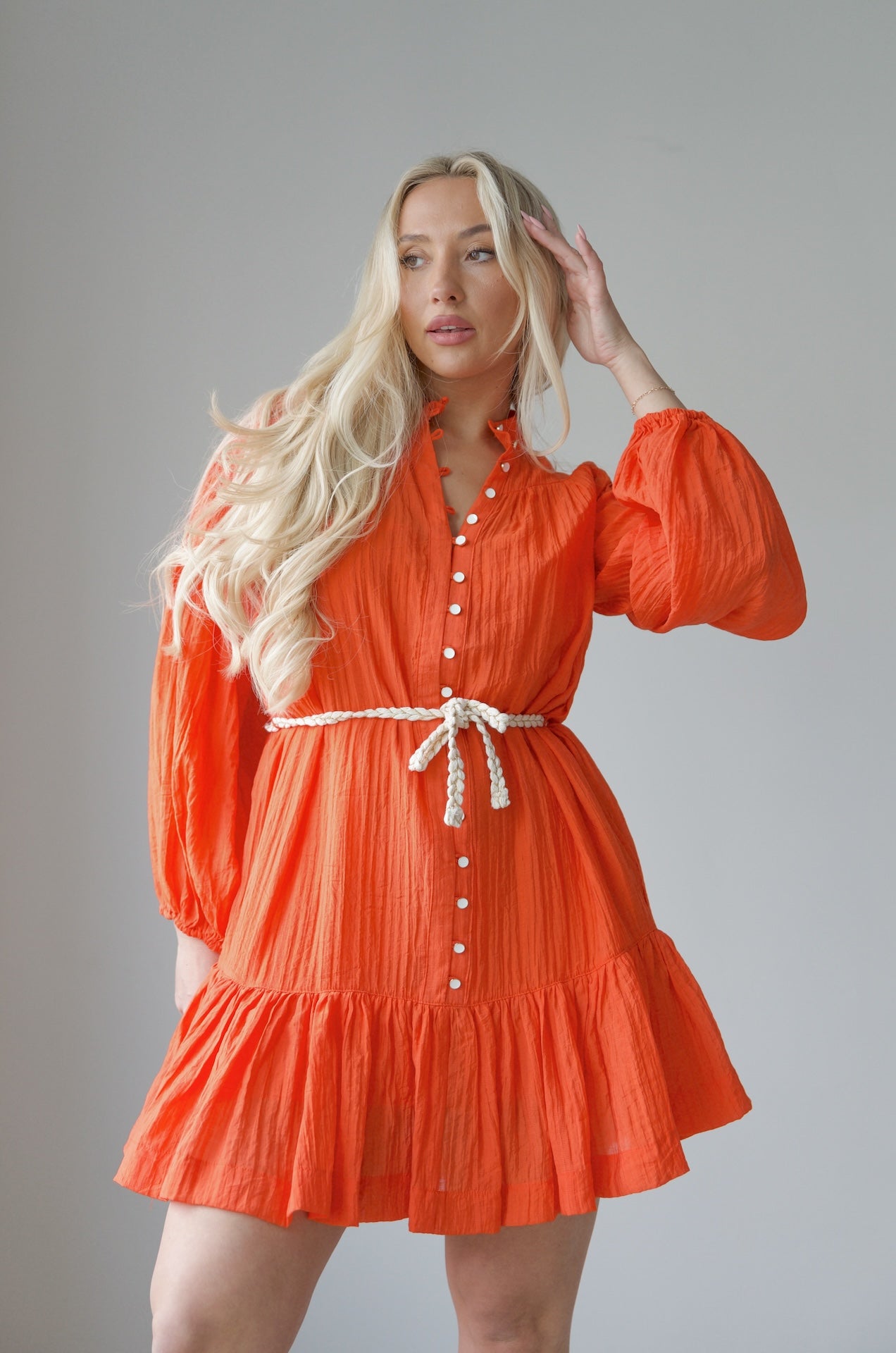 orange long sleeve mini dress with a braided belt