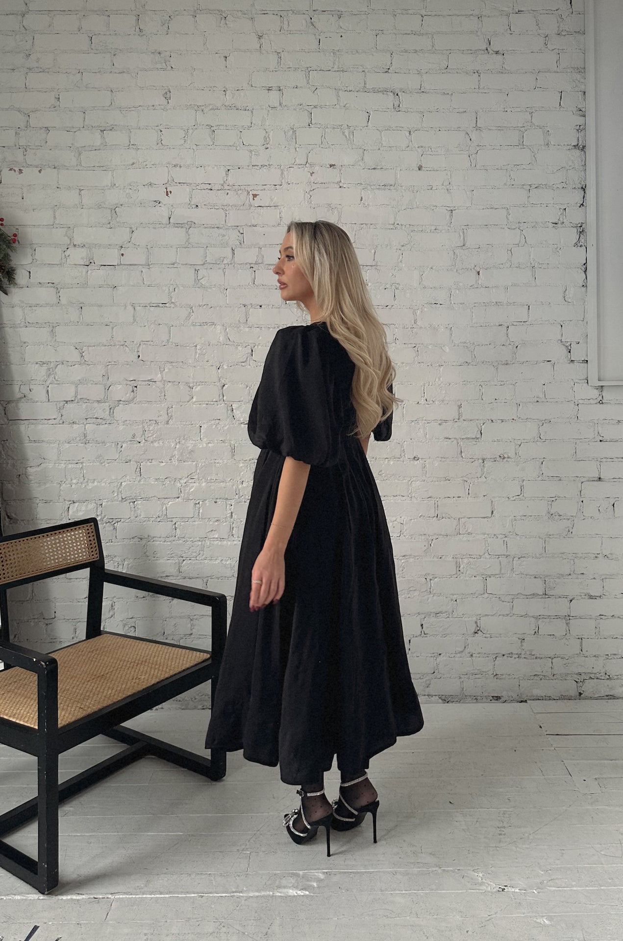 black puff sleeve midi dress with a belt and v-neckline