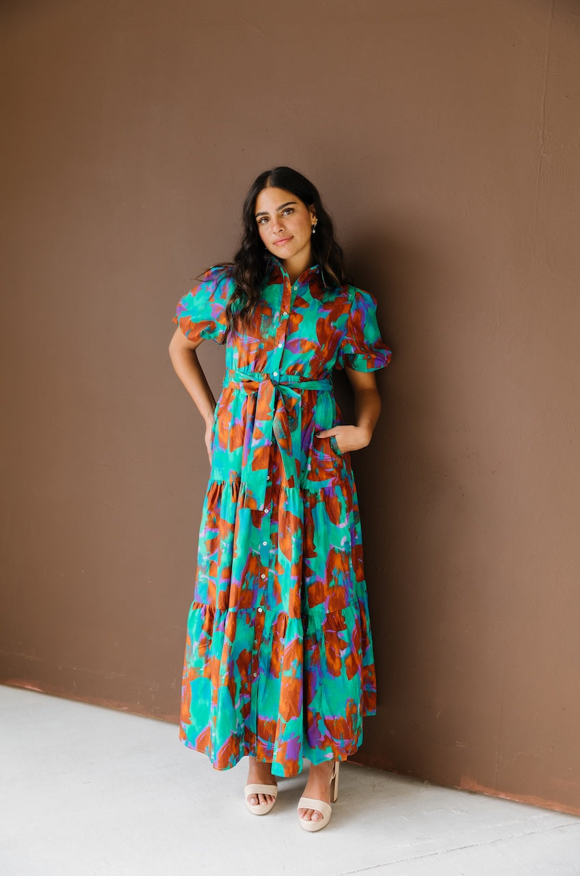 Green and brown puff sleeve button down cotton shirt dress with maxi length, waist tie and side pockets.