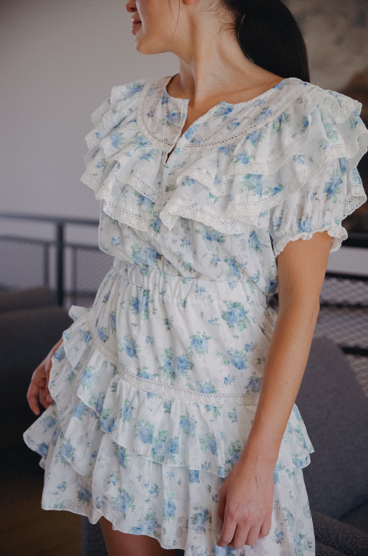 white ruffle mini dress with sleeves and blue floral print