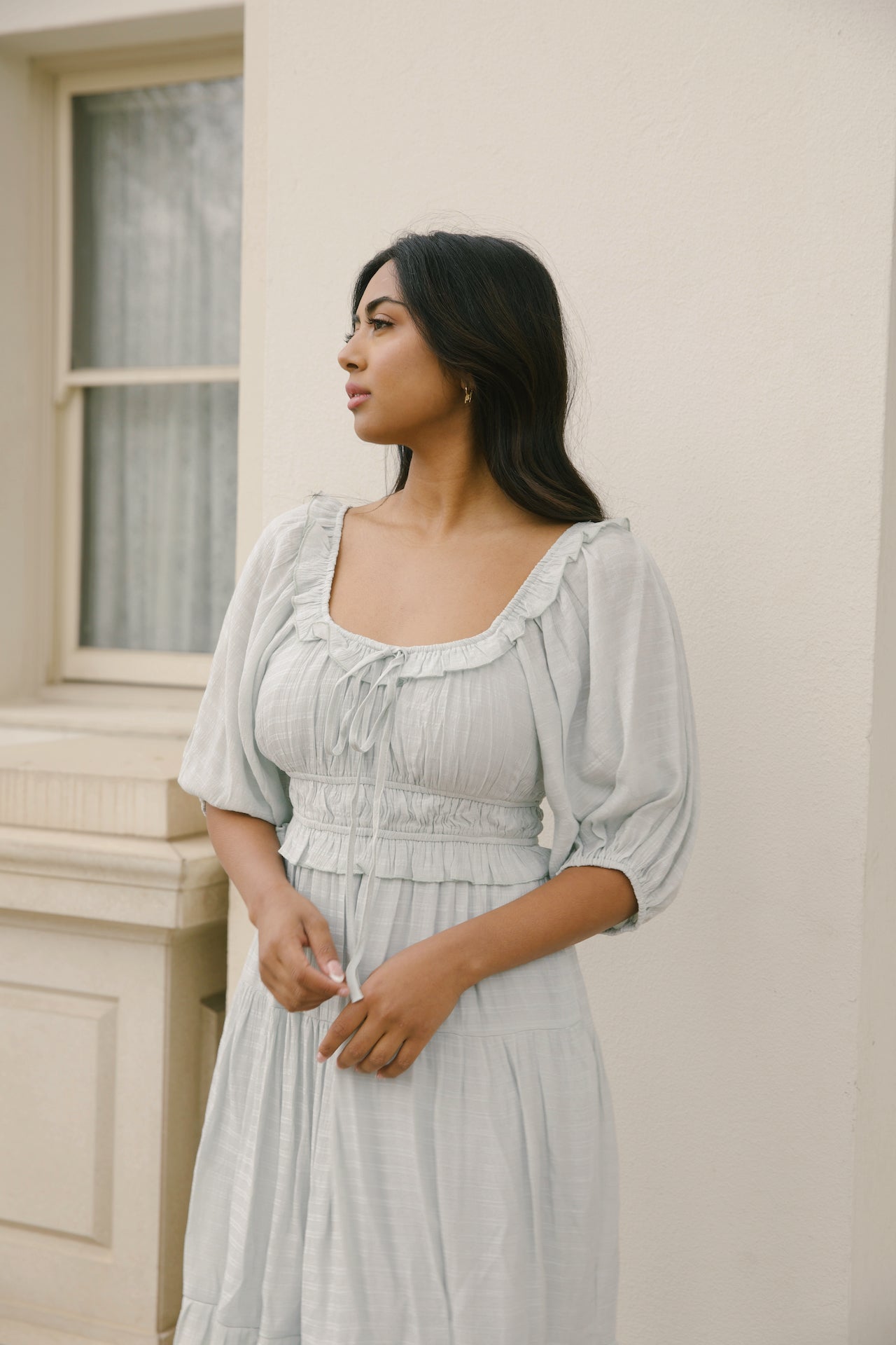 sage midi dress with puff sleeves, ruffles and a tiered midi dress style