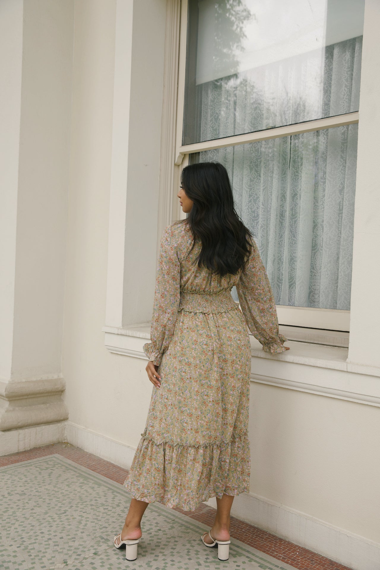 green floral midi dress with long sleeves and a smocked waistline