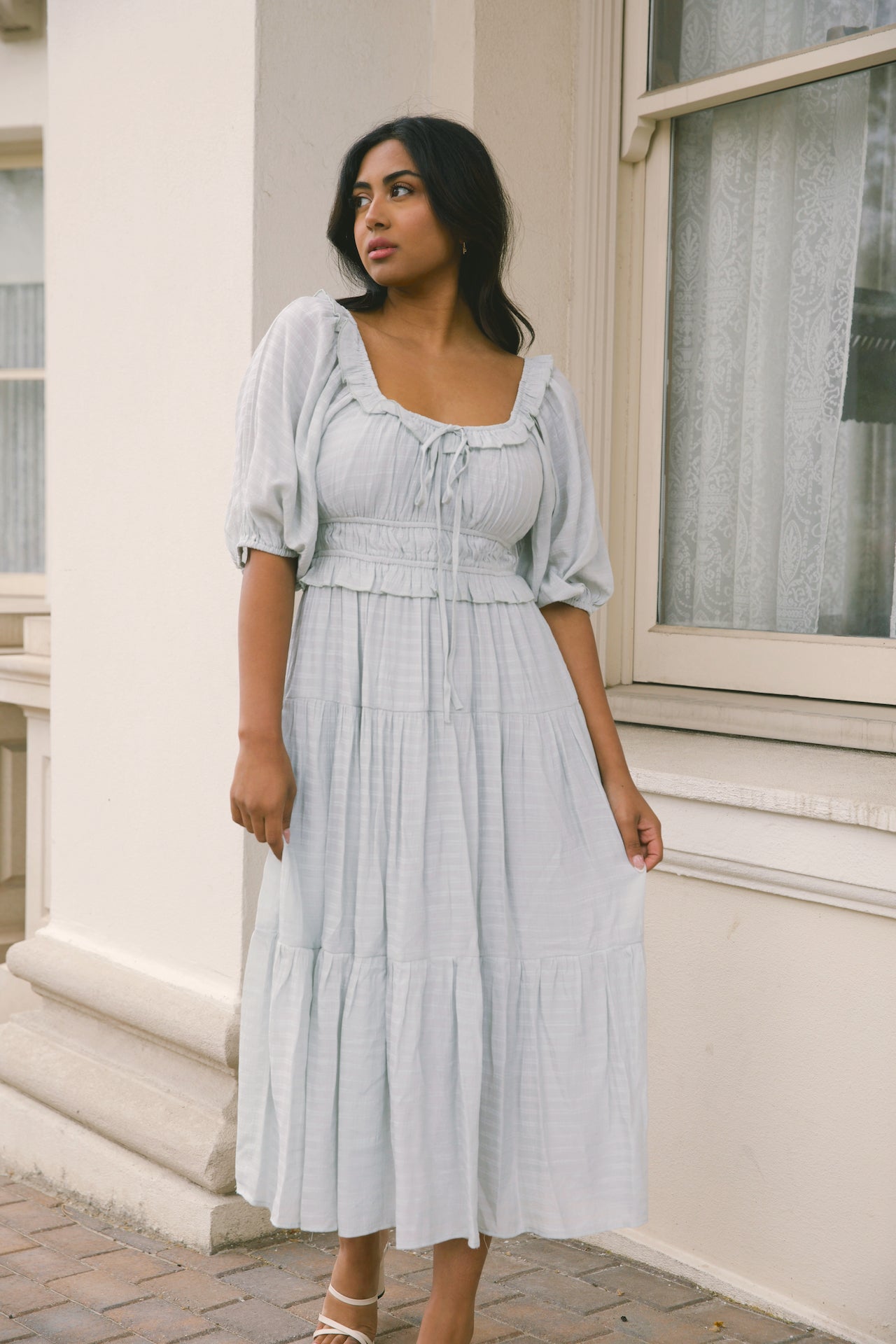 sage midi dress with puff sleeves, ruffles and a tiered midi dress style