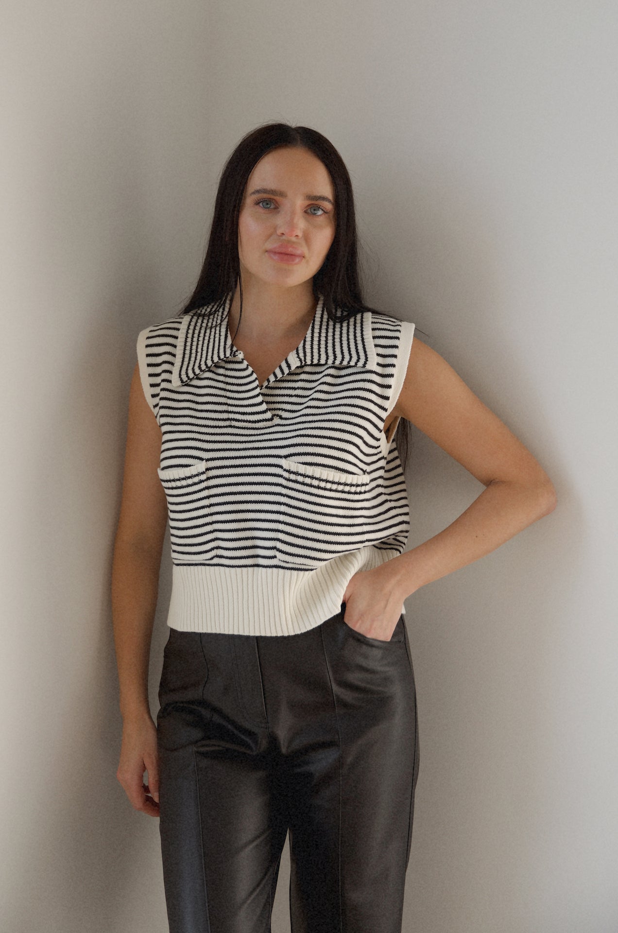 black and white striped sweater vest that is collared with pockets