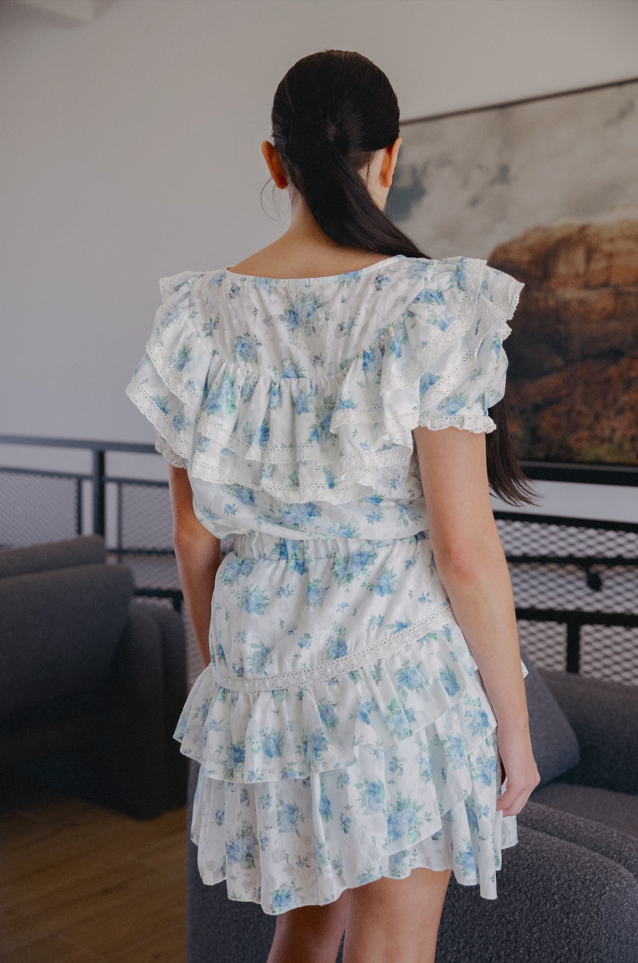 white ruffle mini dress with sleeves and blue floral print