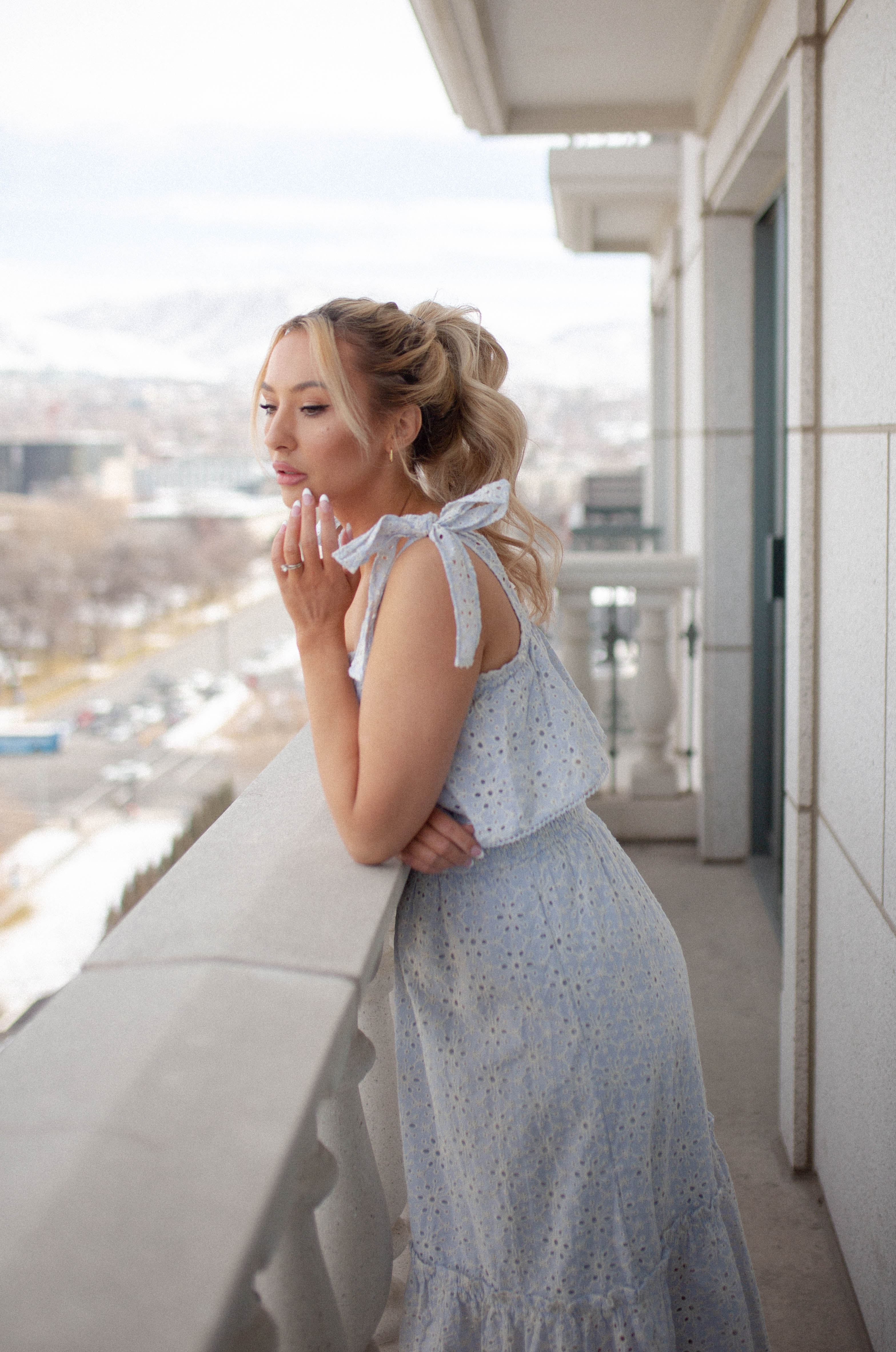 feminine and girly details on the light blue eyelet midi dress. The hand tied bow shoulder straps add the perfect touch. 