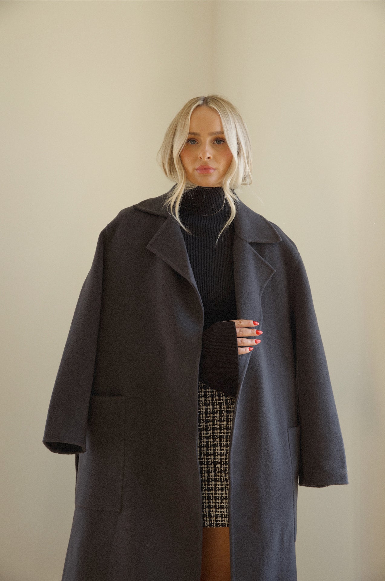 womens black wool coat that is belted with pockets