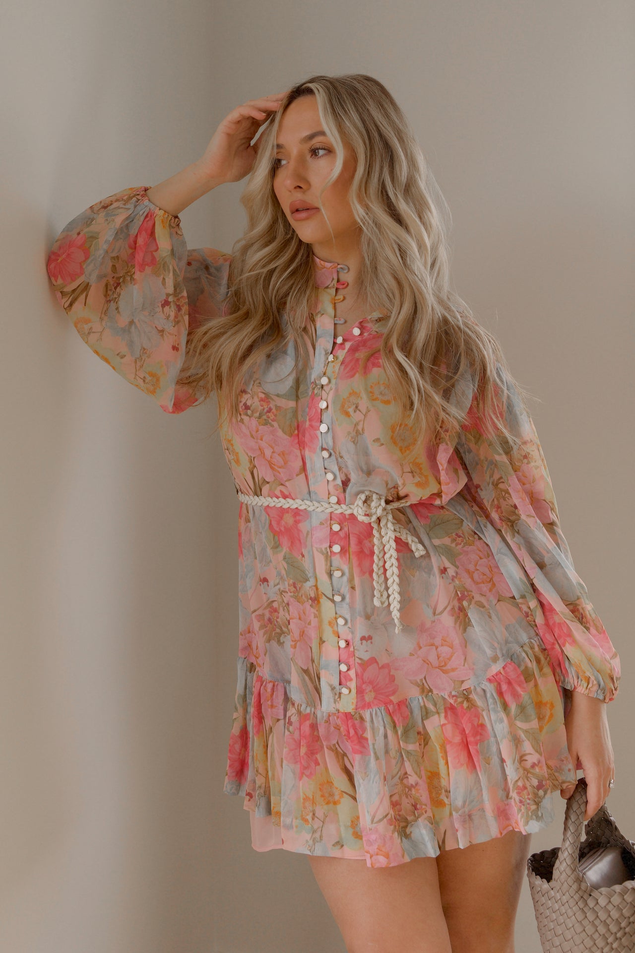 pink and blue floral sheer mini dress with long sleeves and a braided waist tie